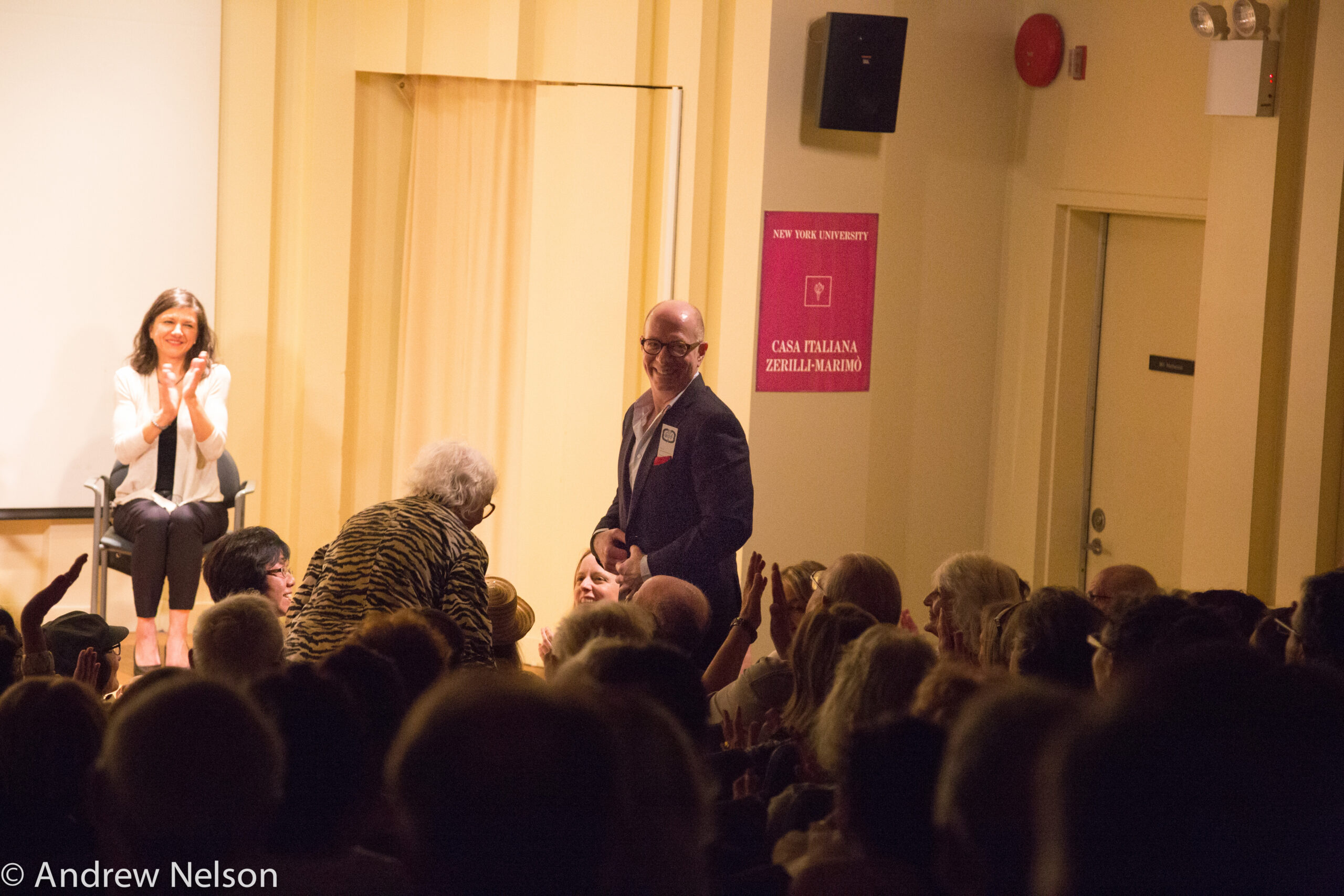 man-smiling-and-spectators-clapping-from-rossini-opera-festival-at-casa-italiana