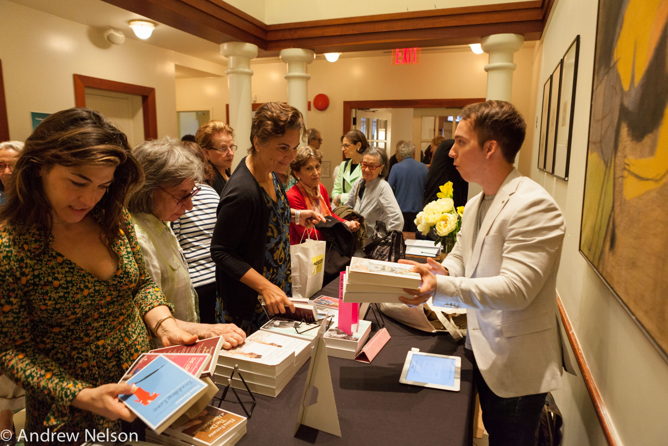 people-looking-at-books-from-pen-world-voices-festival-at-casa-italiana