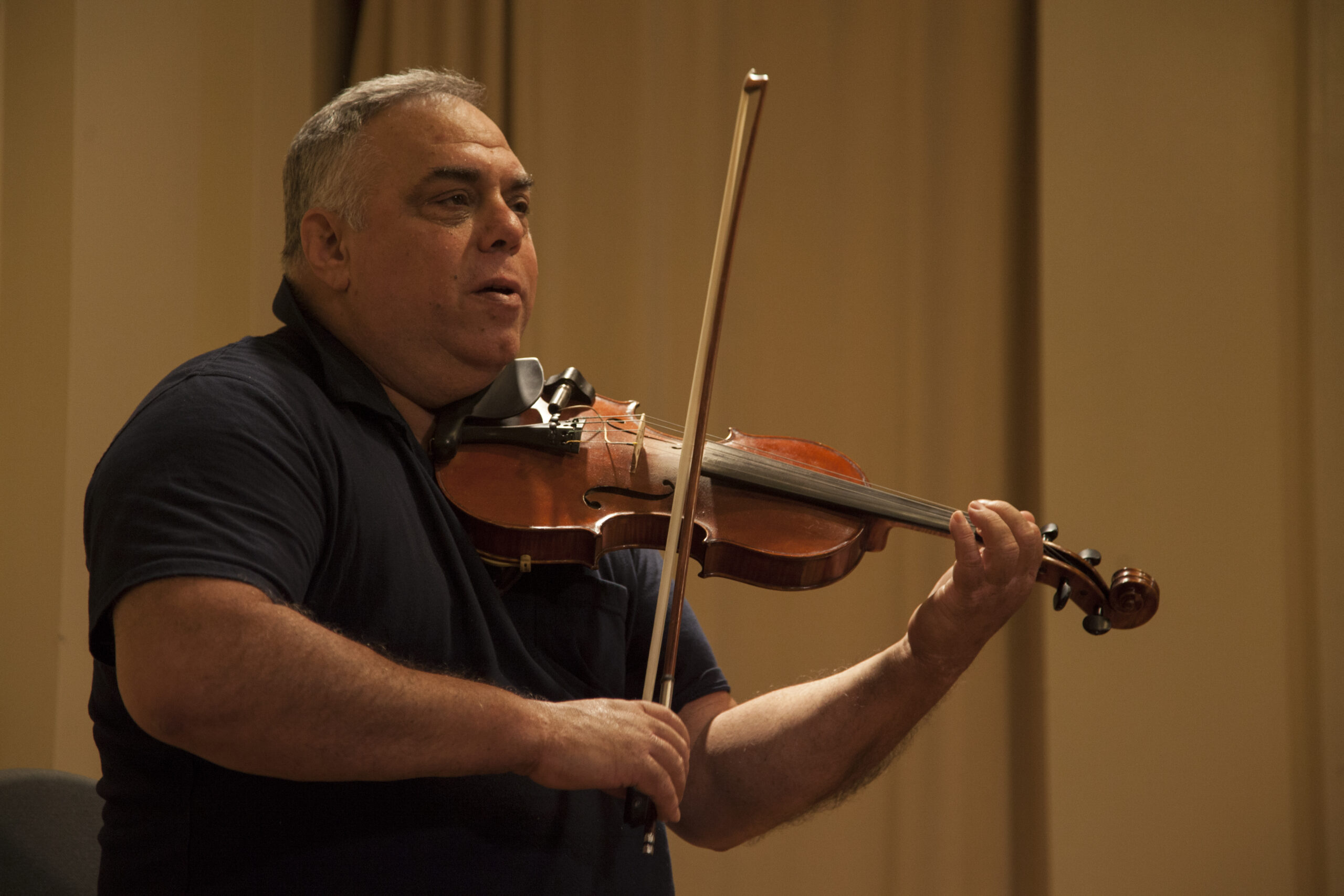 musician-playing-violin-from-book-presentation-an-unlikely-union-at-casa-italiana