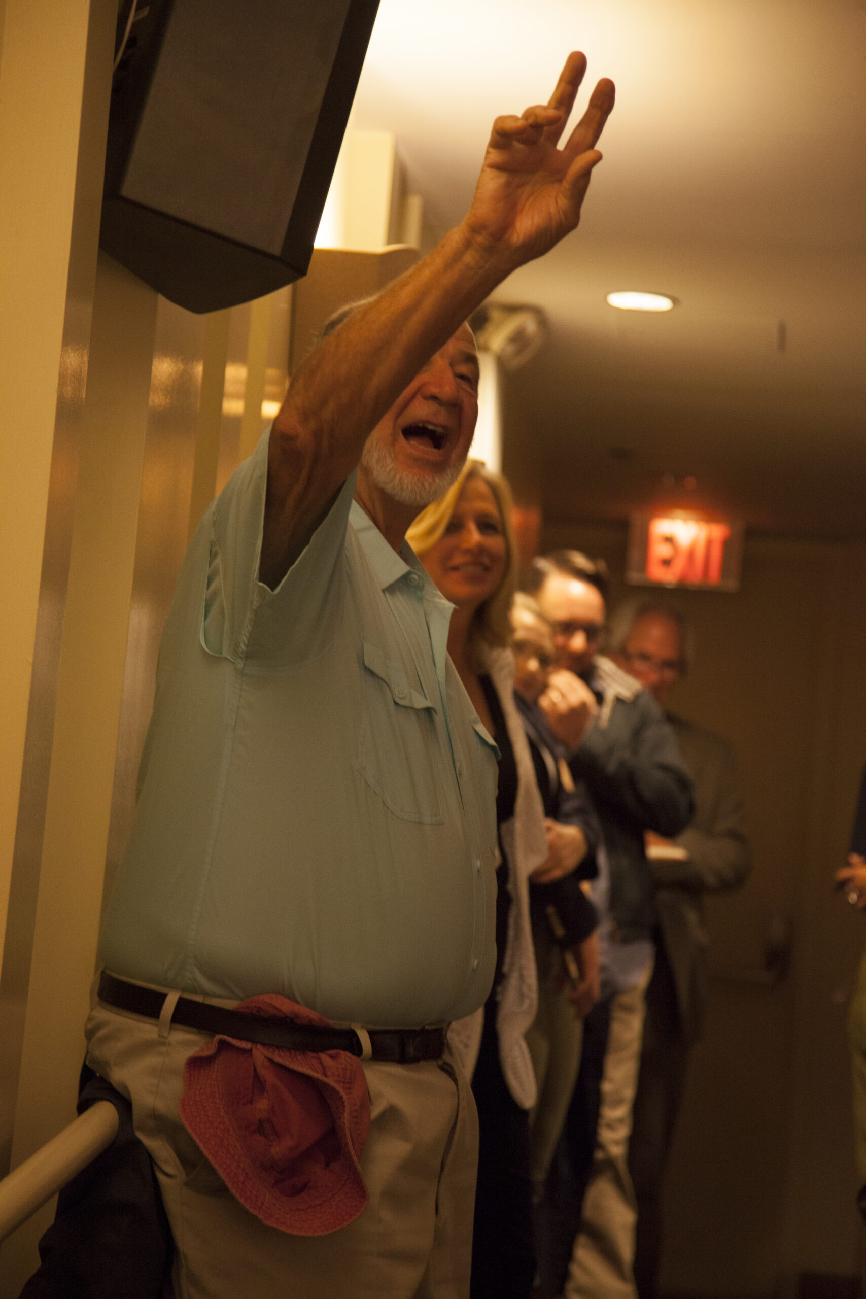 man-waving-hand-from-book-presentation-an-unlikely-union-at-casa-italiana