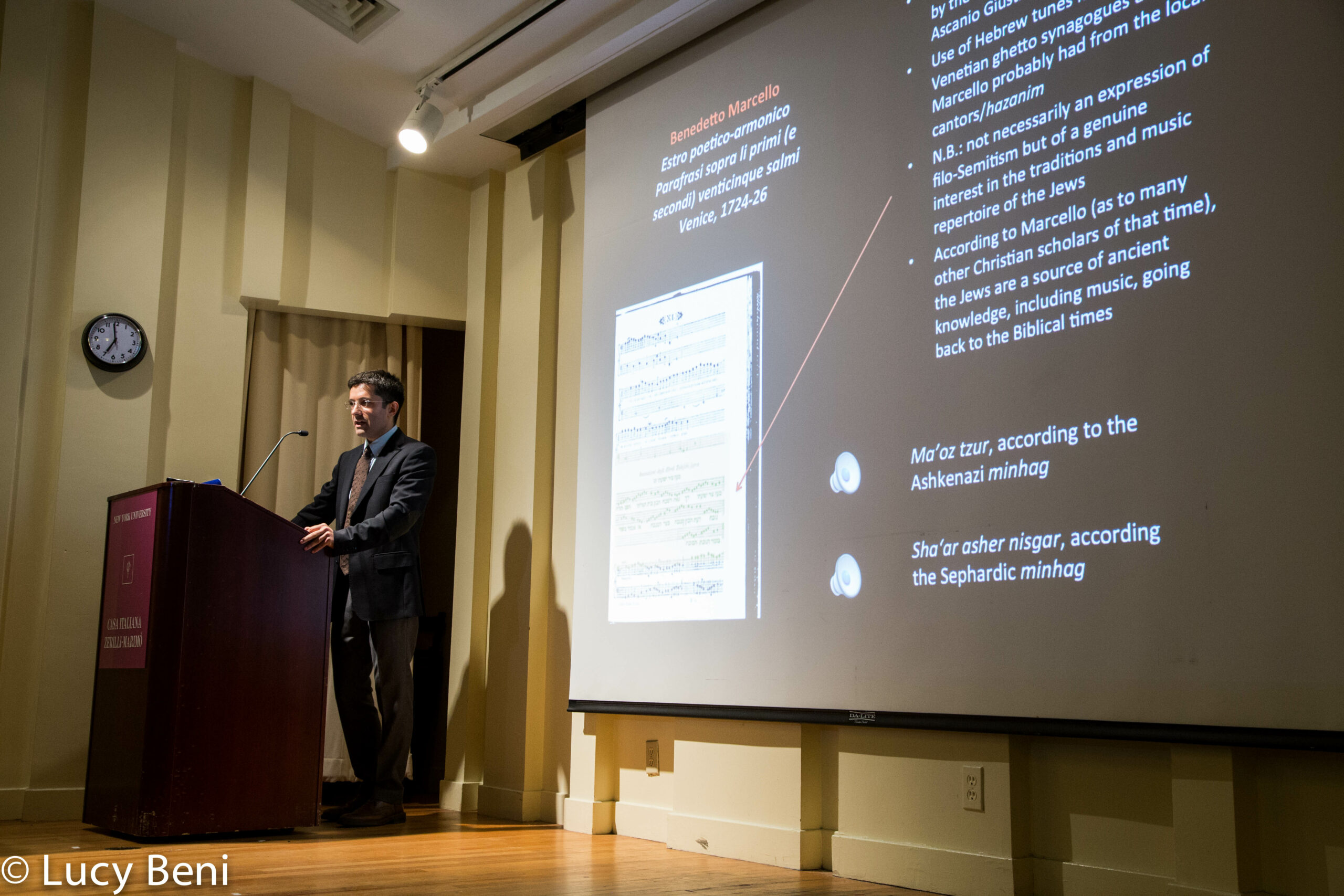 speaker-talking-and-projector-screen-from-the-ghetto-to-cappella-at-casa-italiana