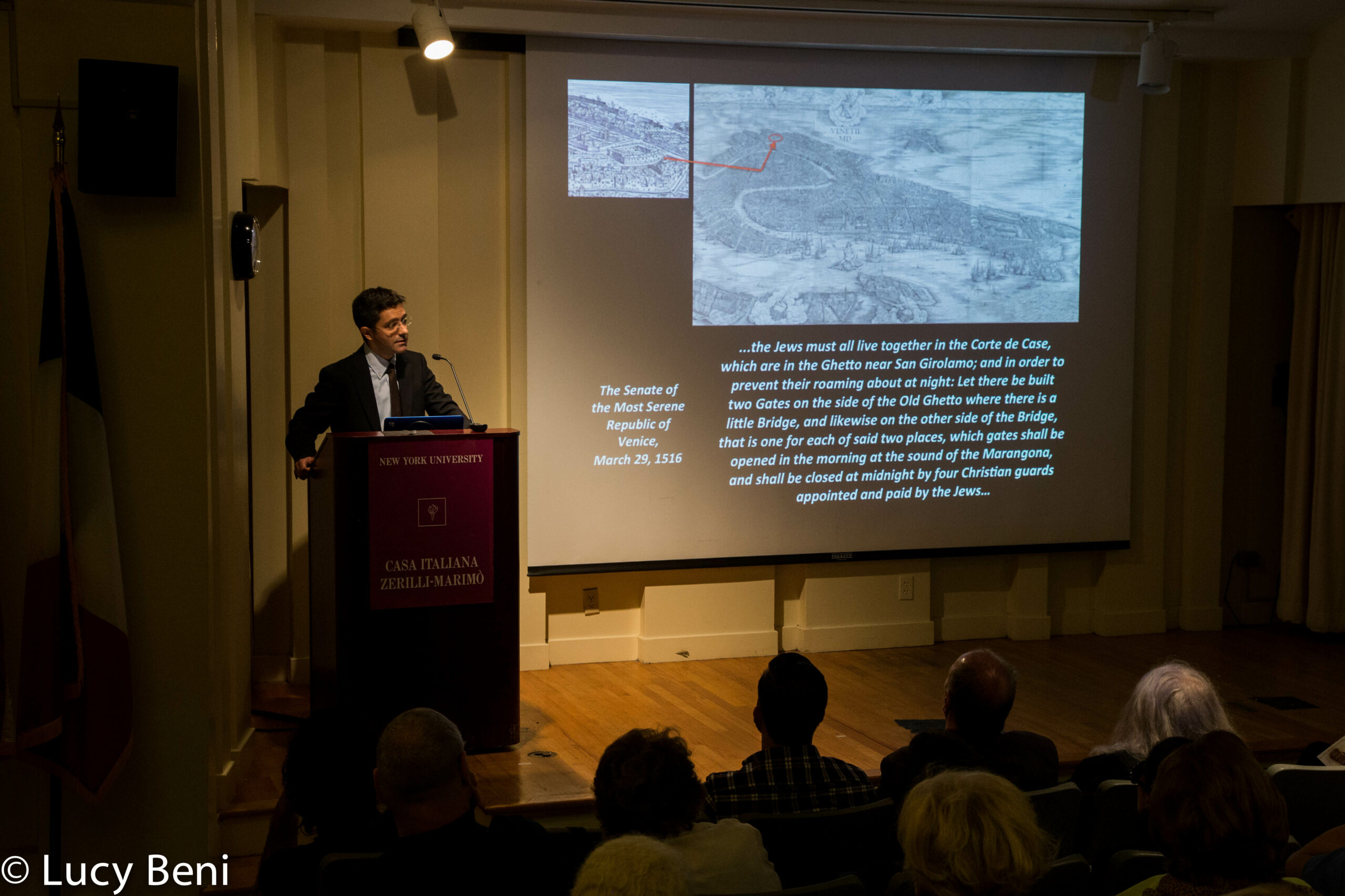 speaker-talking-and-projector-screen-from-the-ghetto-to-cappella-at-casa-italiana