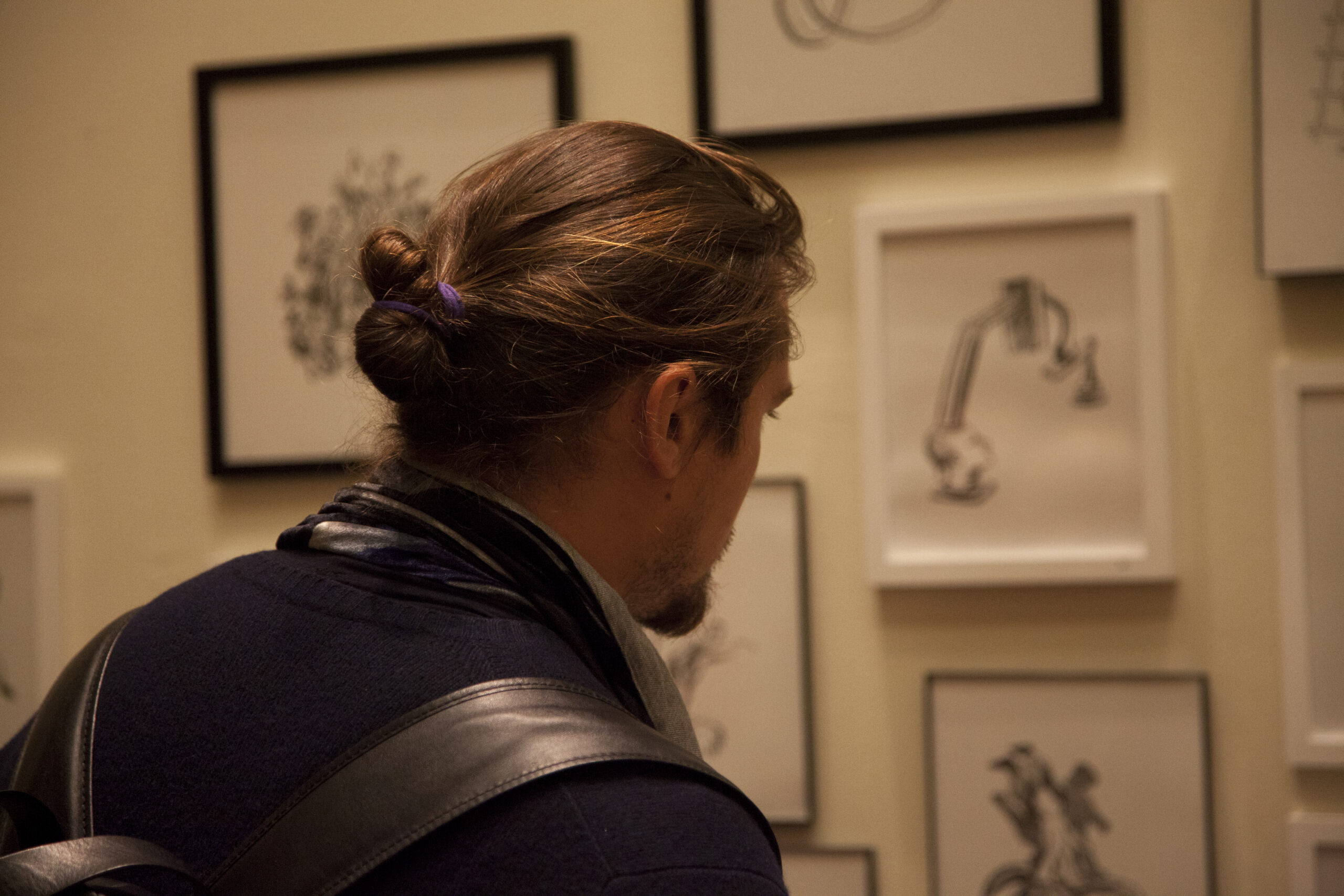 man-seeing-artwork-from-diffraction-exhibition-opening-and-the-fat-man-arpeggios-book-pres-at-casa-italiana