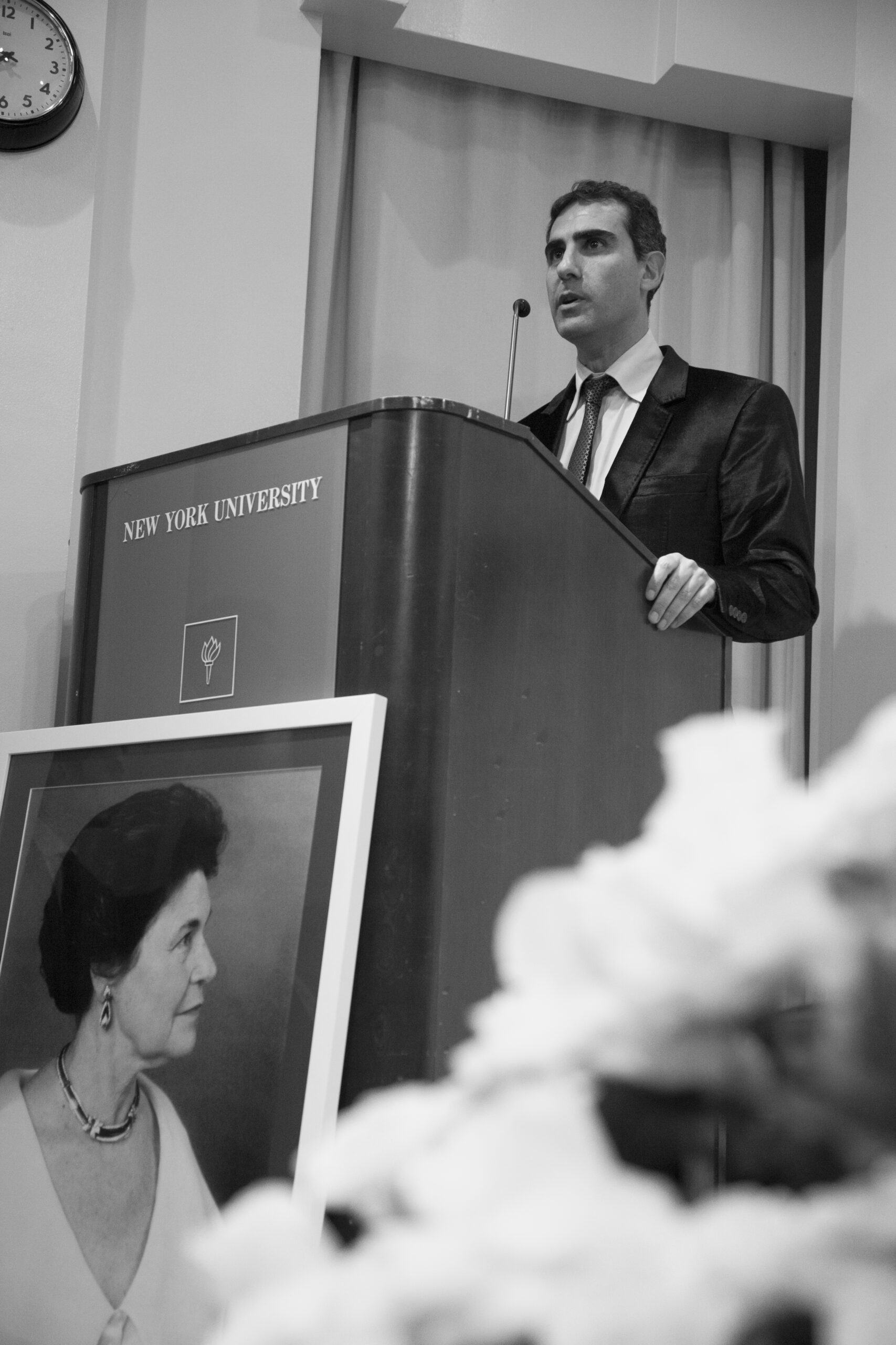 speaker-talking-from-a-tribute-in-words-and-music-for-baroness-mariuccia-zerilli-marim-at-casa-italiana