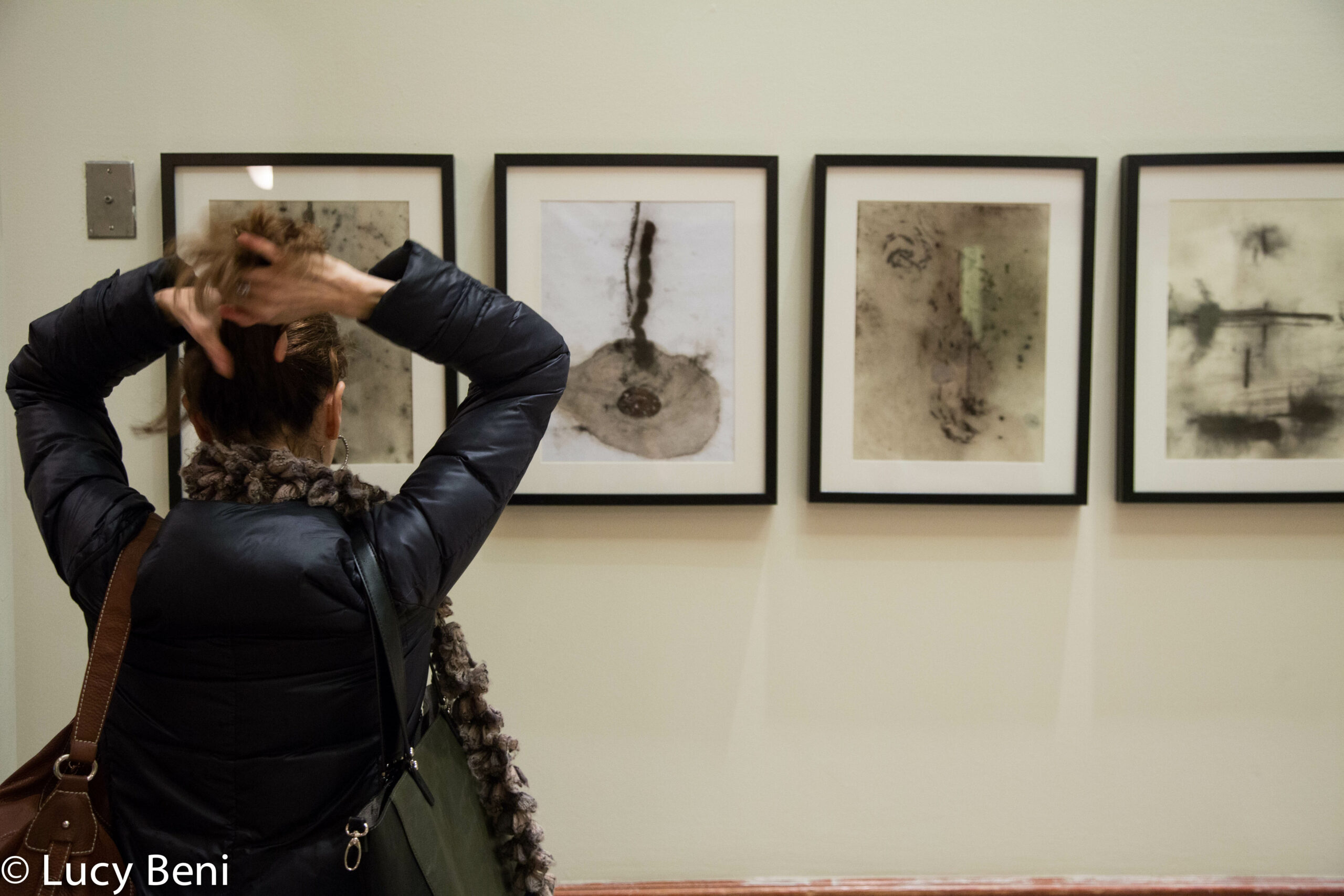 woman-seeing-exhibit-from-exhibiton-opening-works-by-roberto-almagno-at-casa-italiana