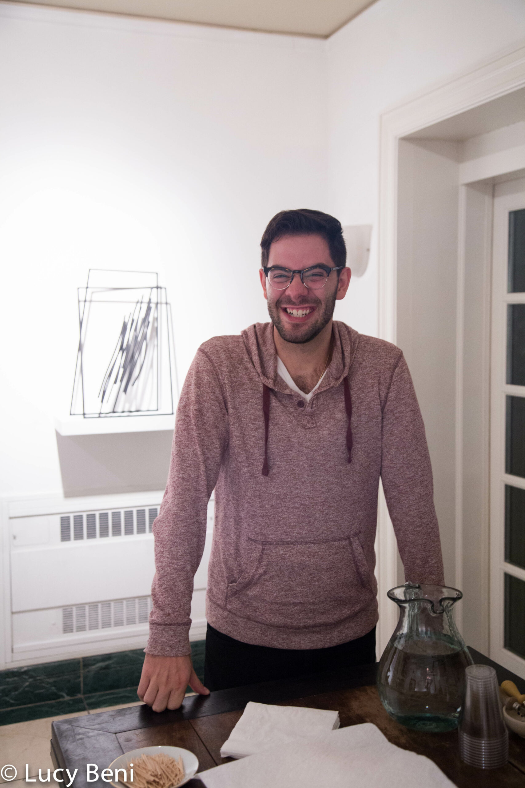 man-smiling-from-exhibiton-opening-works-by-roberto-almagno-at-casa-italiana