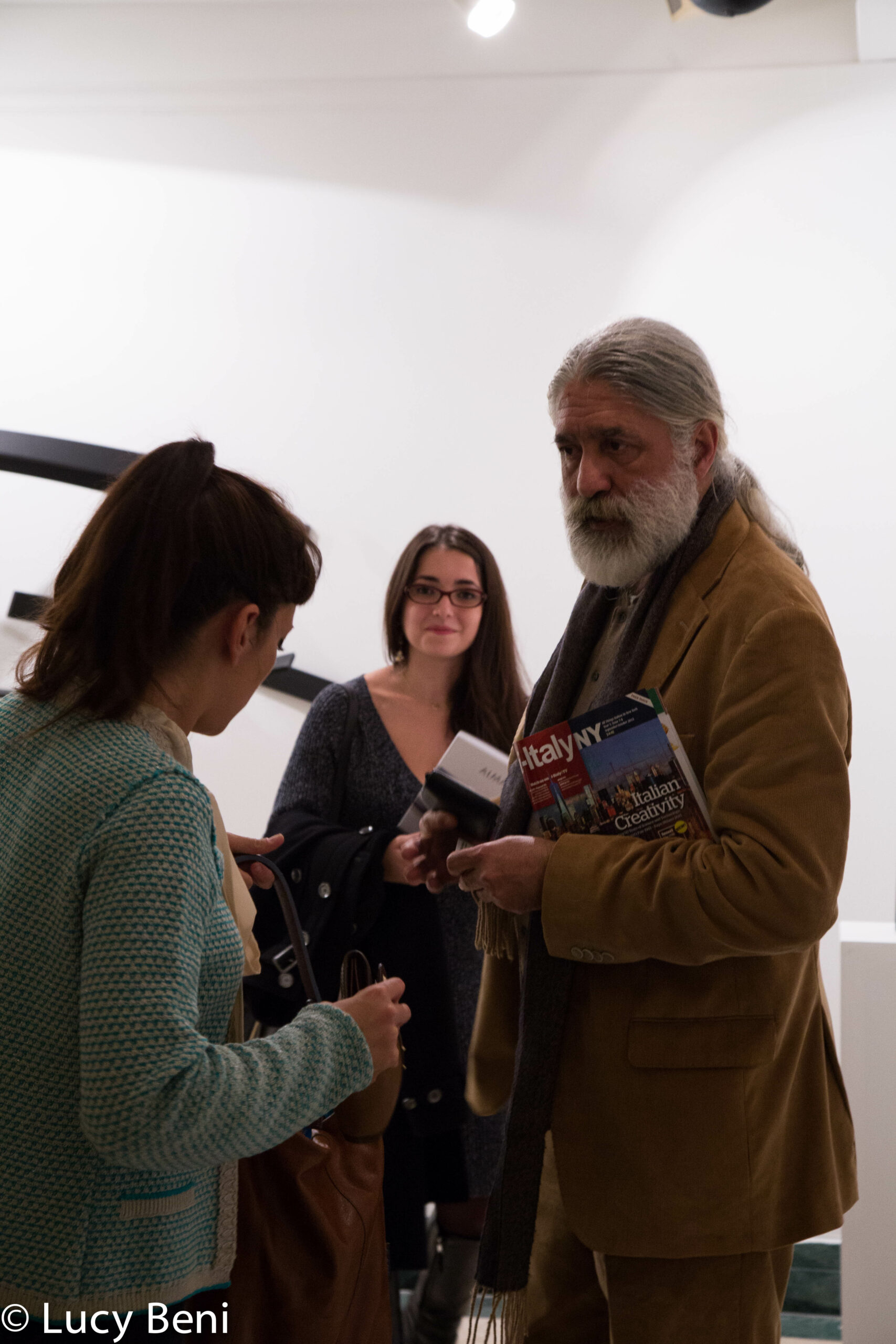 artist-talking-to-people-from-exhibiton-opening-works-by-roberto-almagno-at-casa-italiana