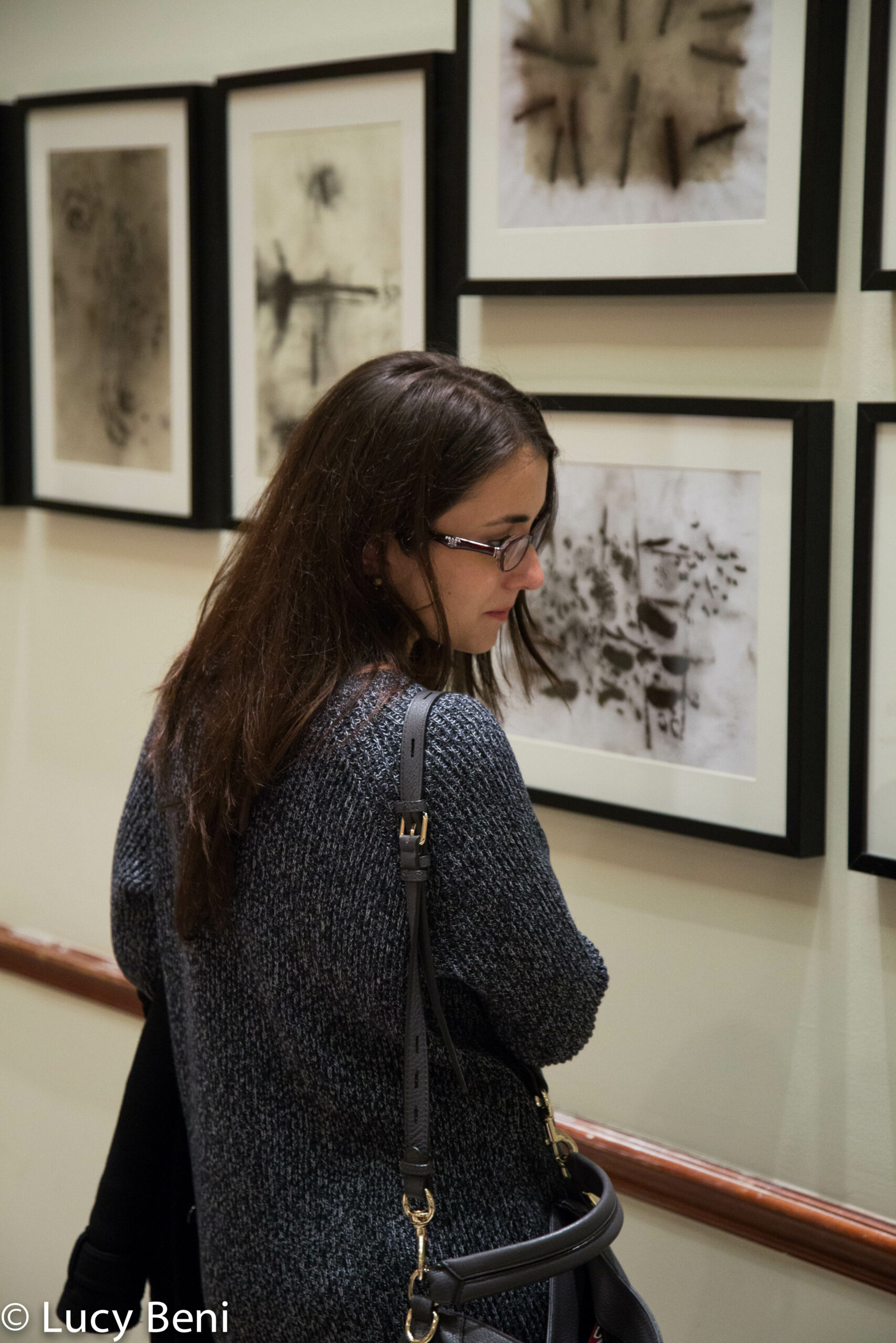 woman-seeing-exhibit-from-exhibiton-opening-works-by-roberto-almagno-at-casa-italiana