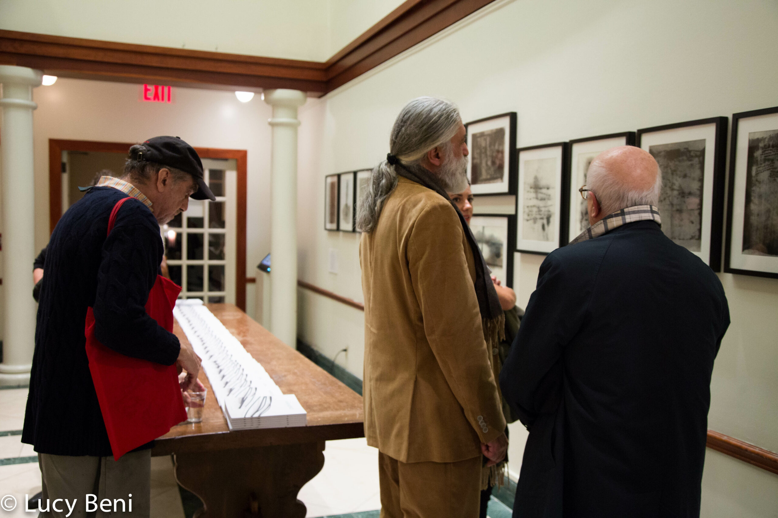 artist-talking-to-people-from-exhibiton-opening-works-by-roberto-almagno-at-casa-italiana