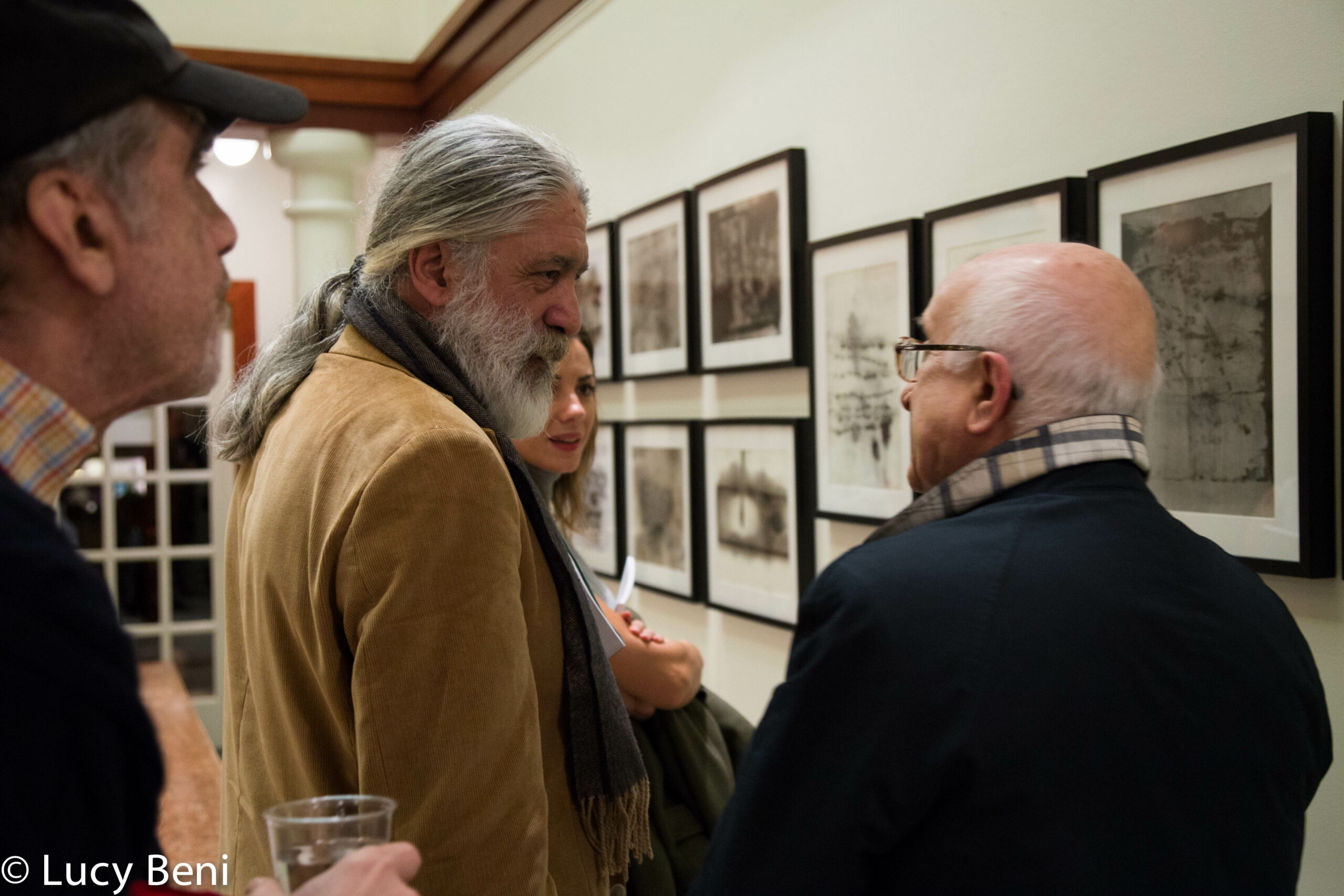 artist-talking-to-people-from-exhibiton-opening-works-by-roberto-almagno-at-casa-italiana