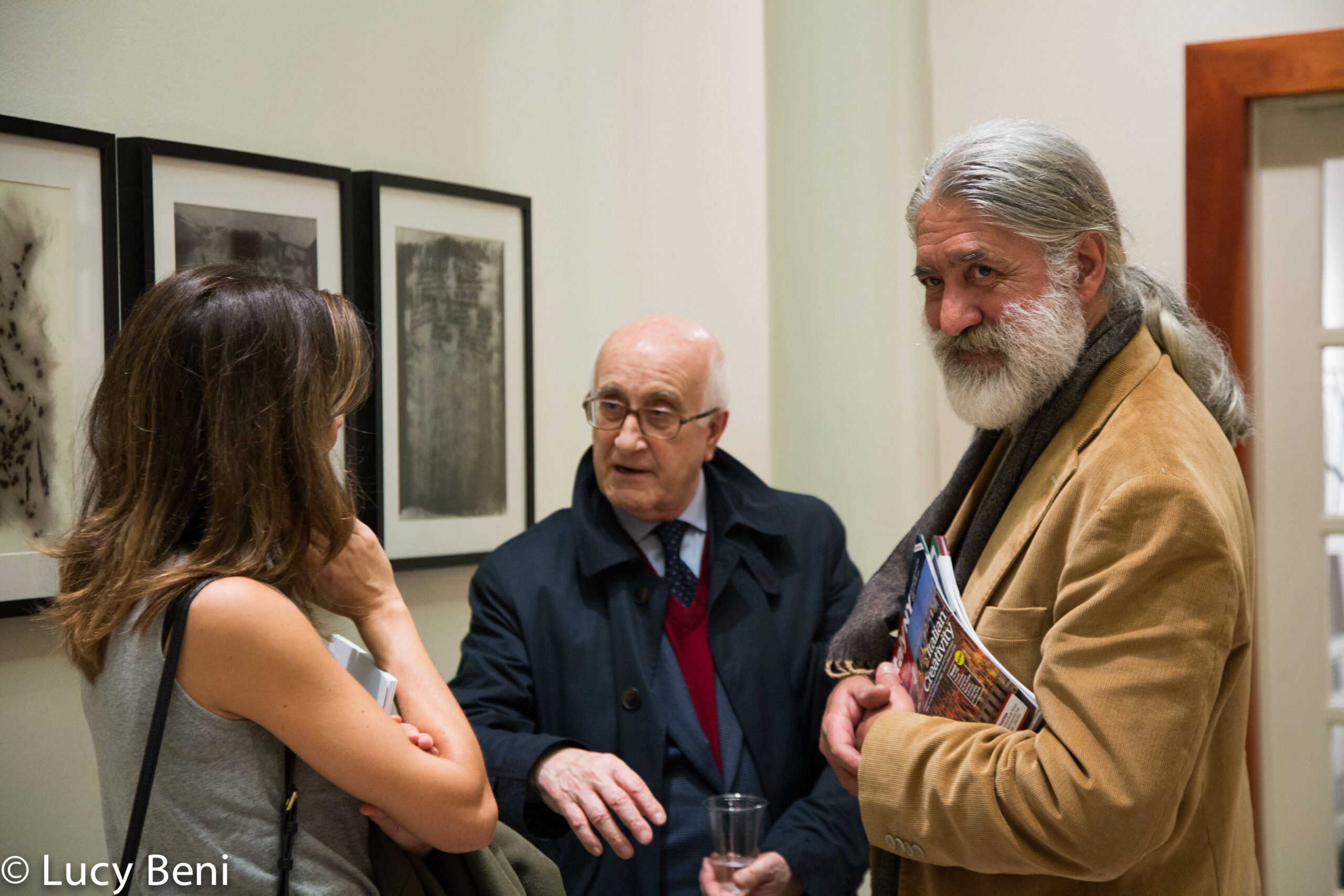 artist-talking-to-people-from-exhibiton-opening-works-by-roberto-almagno-at-casa-italiana