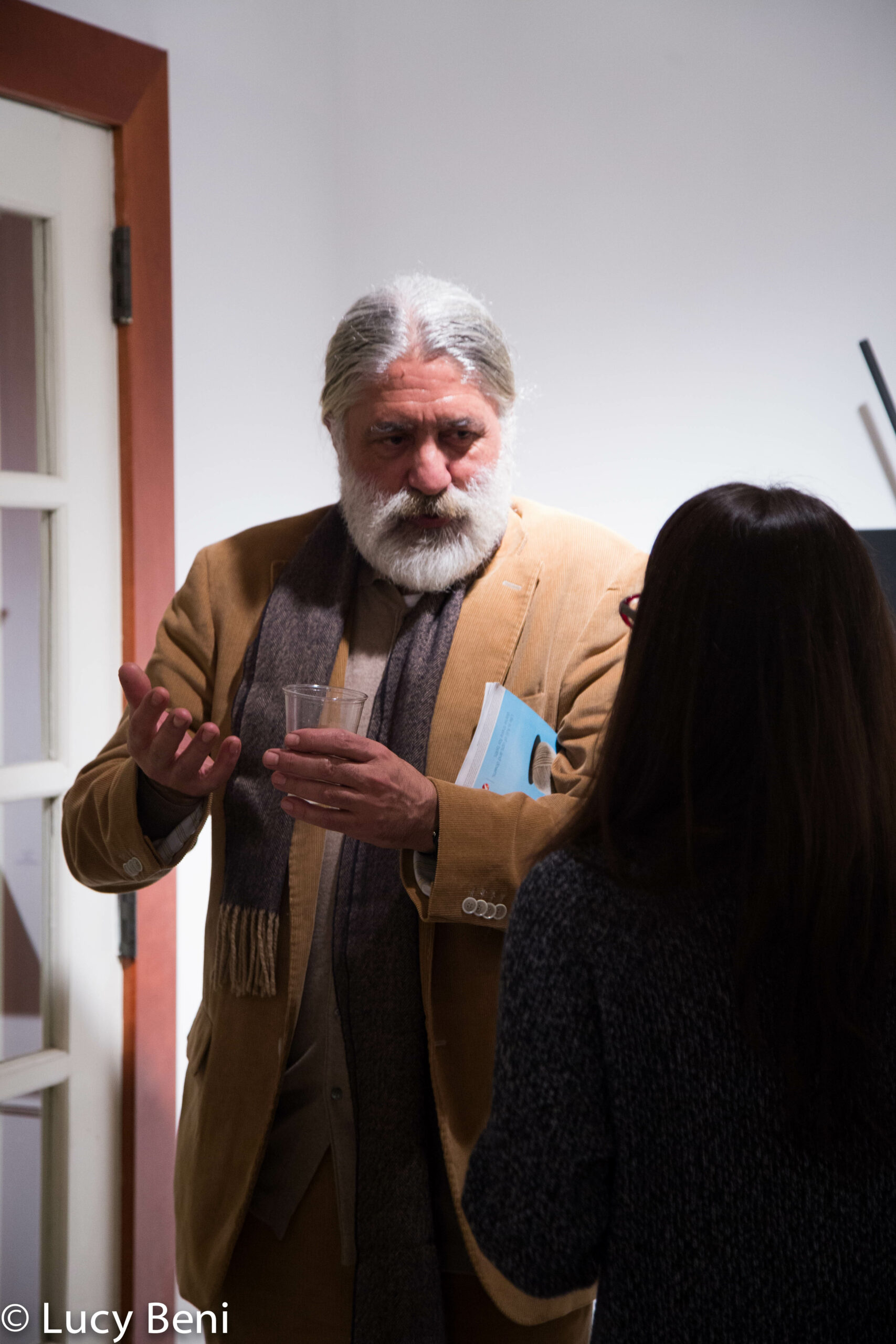artist-talking-to-girl-from-exhibiton-opening-works-by-roberto-almagno-at-casa-italiana