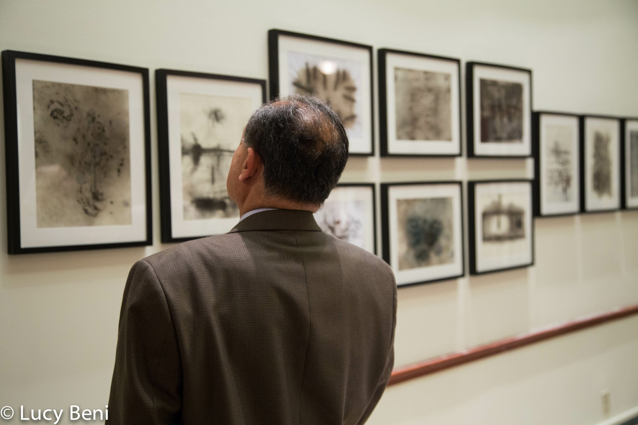 man-seeing-exhibit-from-exhibiton-opening-works-by-roberto-almagno-at-casa-italiana