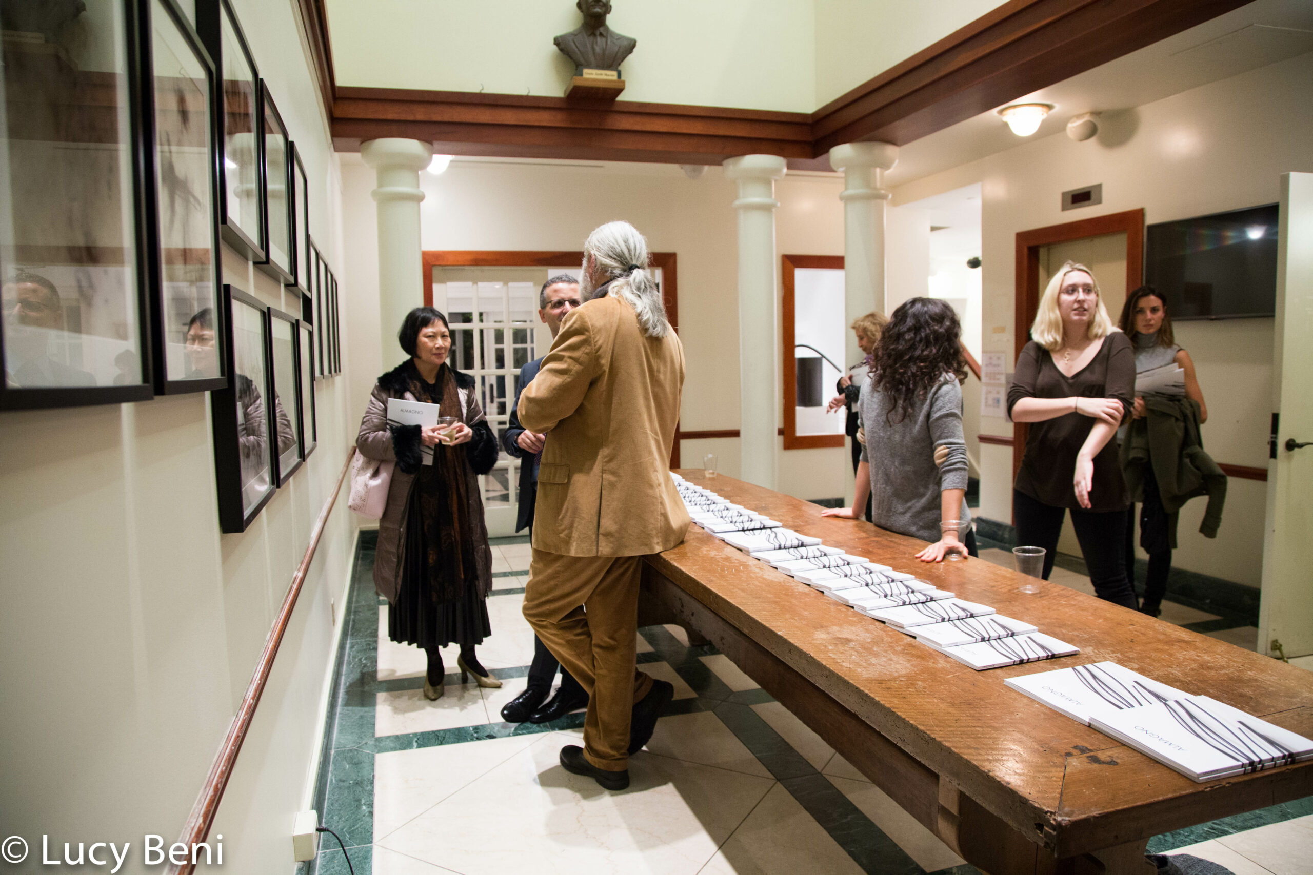 artist-talking-to-people-from-exhibiton-opening-works-by-roberto-almagno-at-casa-italiana