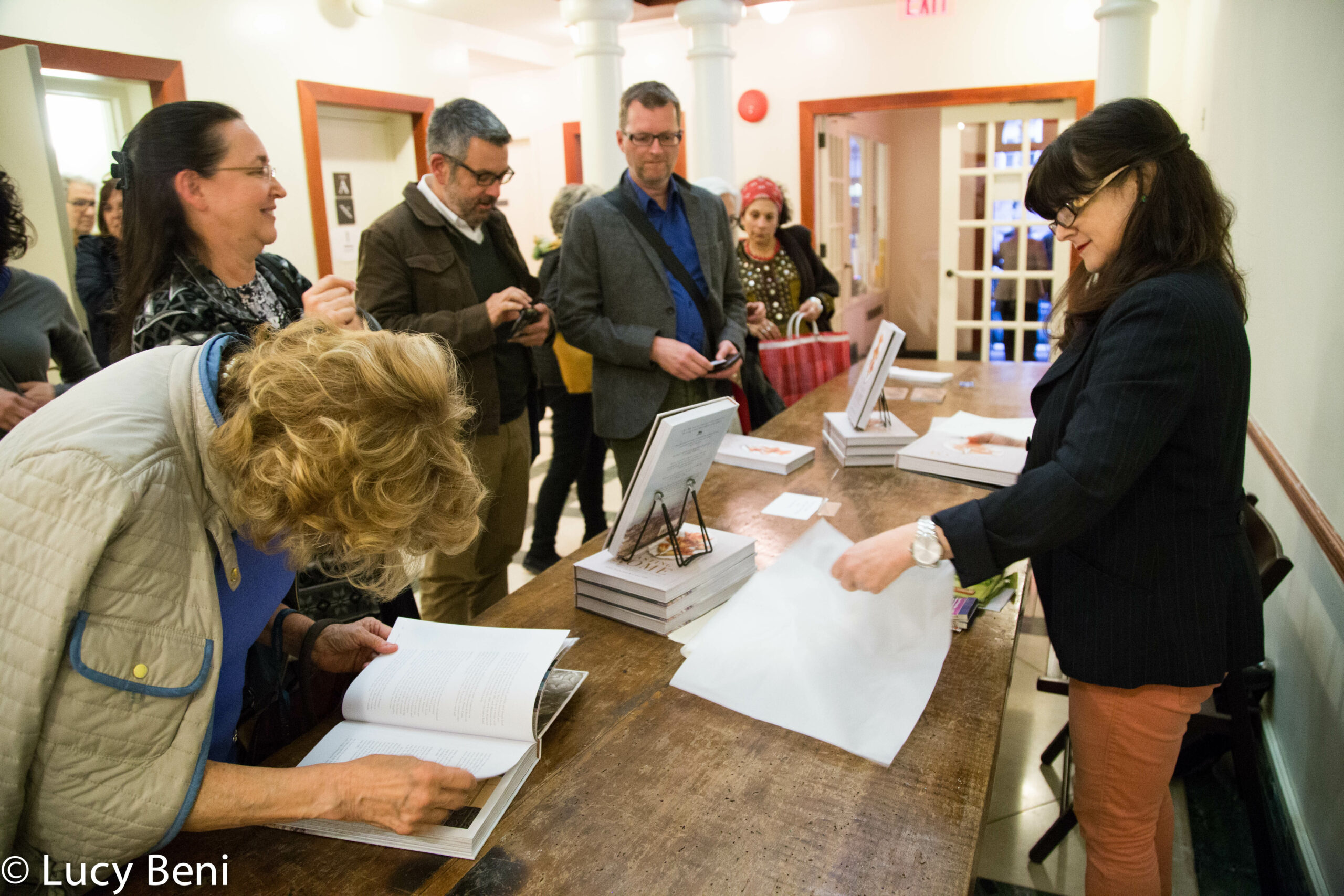people-seeing-books-from-book-presentation-tasting-rome-at-casa-italiana