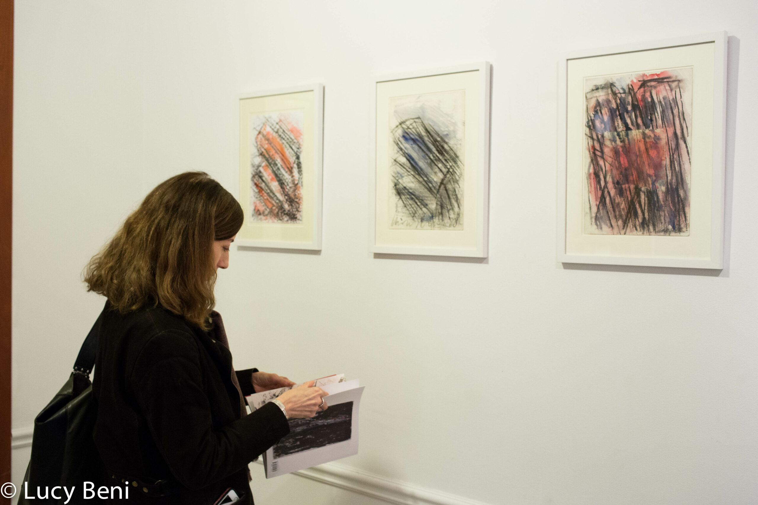 lady-and-artwork-on-wall-from-exhibition-opening-luisa-gardini-at-casa-italiana