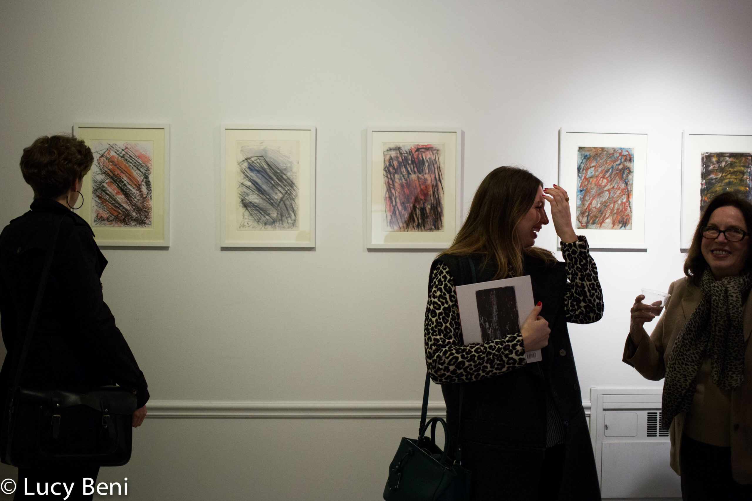 guests-interacting-and-artworks-on-wall-from-exhibition-opening-luisa-gardini-at-casa-italiana