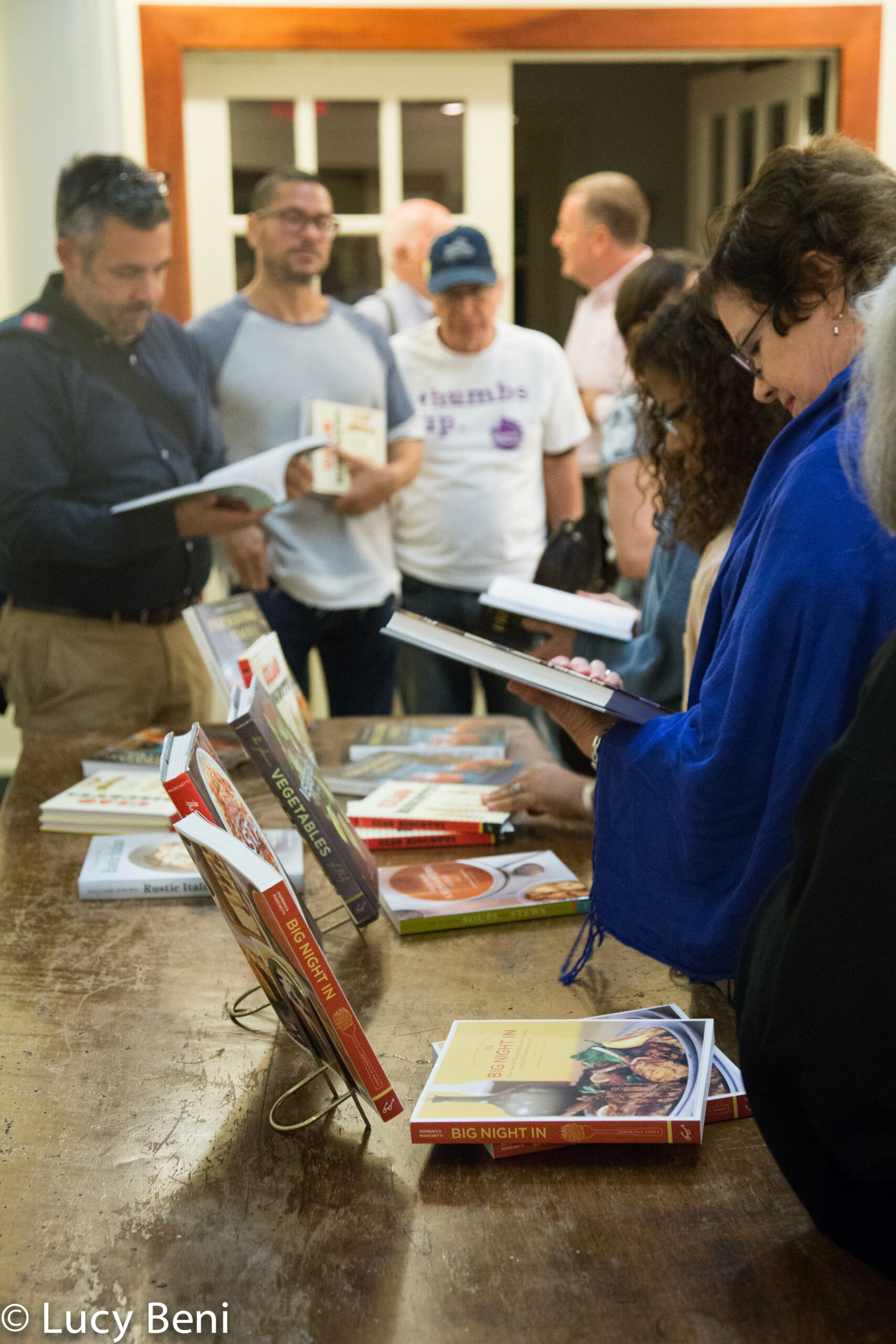 people-looking-at-book-from-book-presentation-preserving-italy-at-casa-italiana