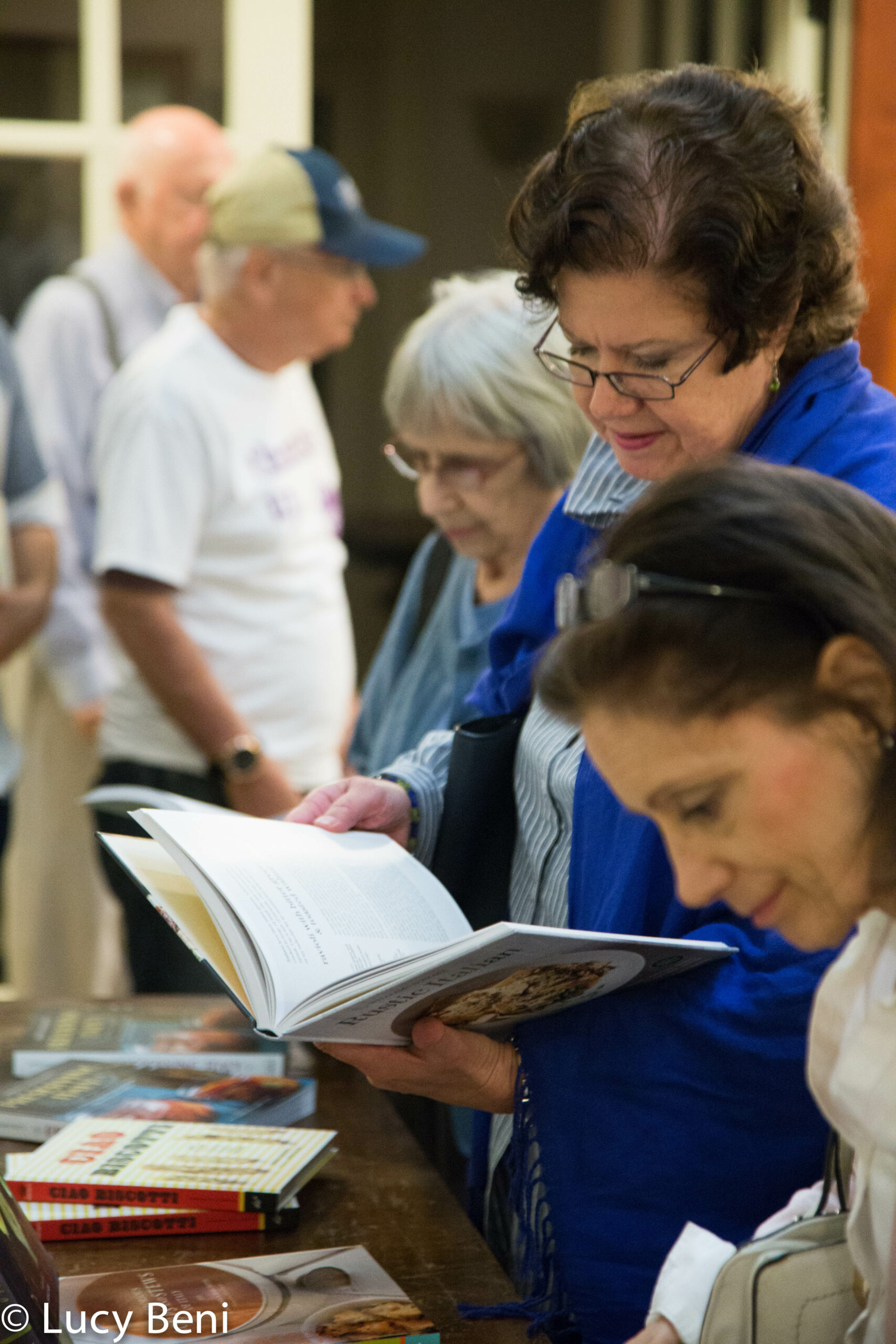 people-looking-at-book-from-book-presentation-preserving-italy-at-casa-italiana