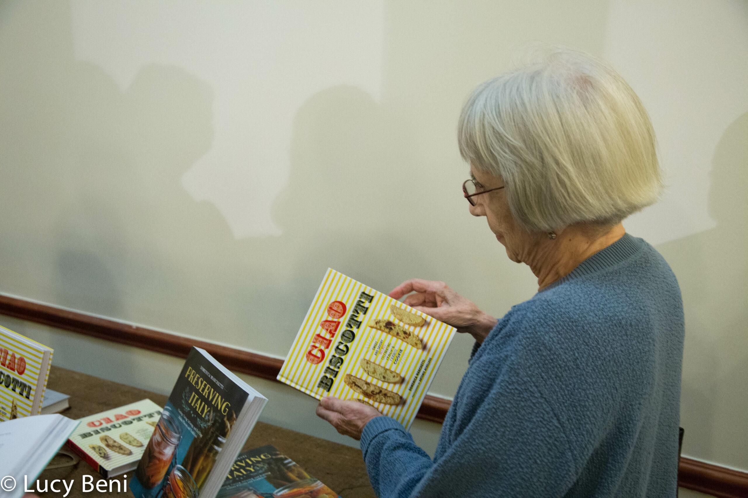 lady-looking-at-book-from-book-presentation-preserving-italy-at-casa-italiana