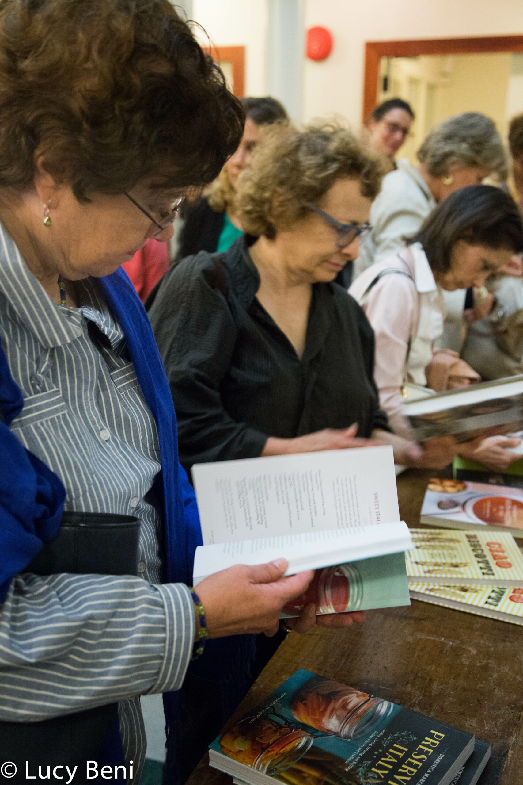 people-looking-at-book-from-book-presentation-preserving-italy-at-casa-italiana