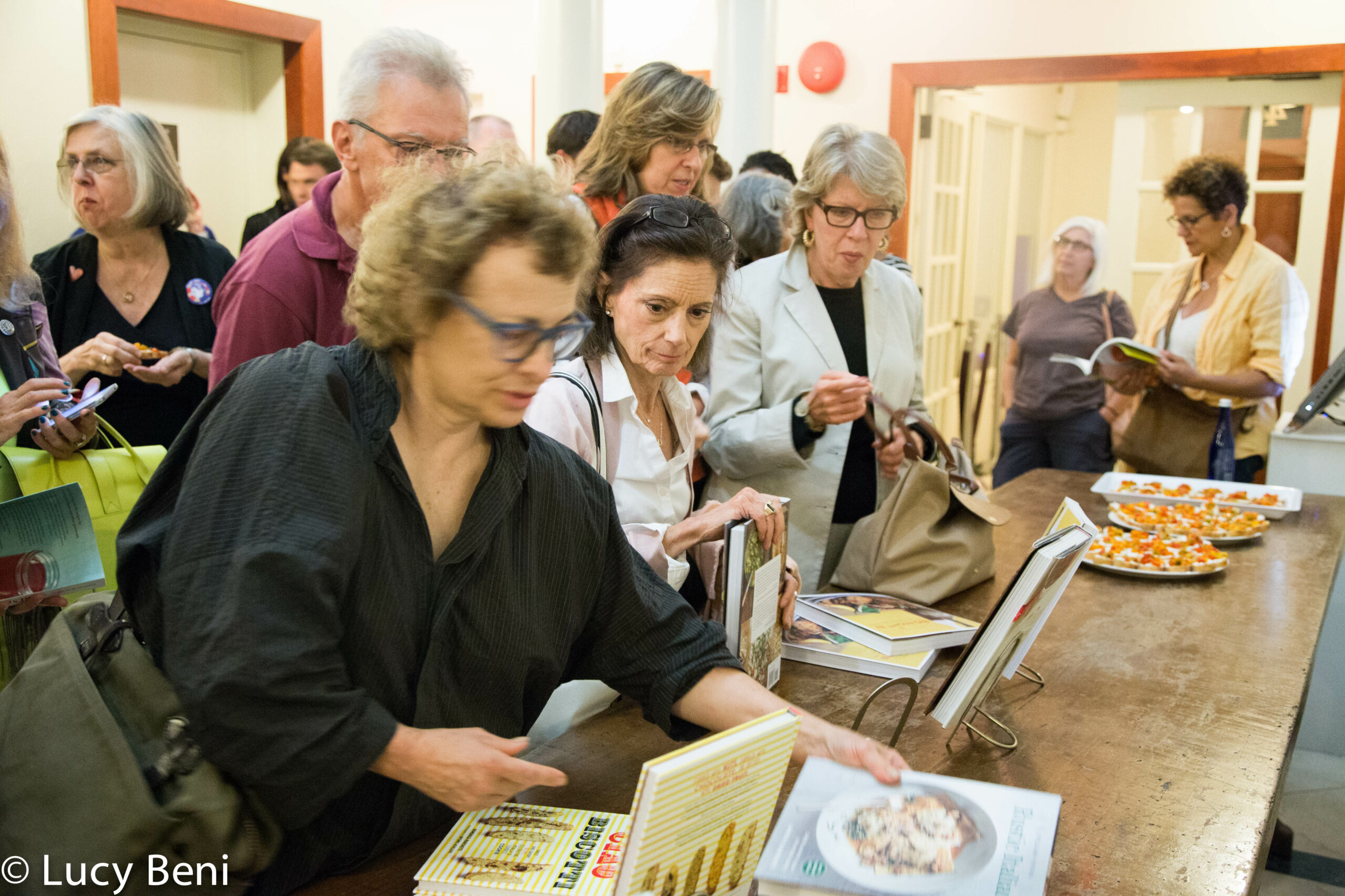 people-looking-at-book-from-book-presentation-preserving-italy-at-casa-italiana