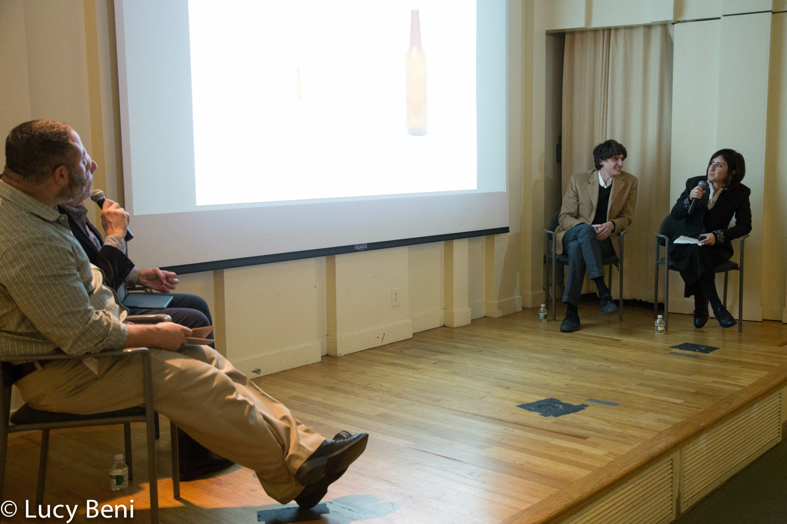 speaker-talking-and-image-being-displayed-on-projector-screen-from-gallery-talk-at-casa-italiana
