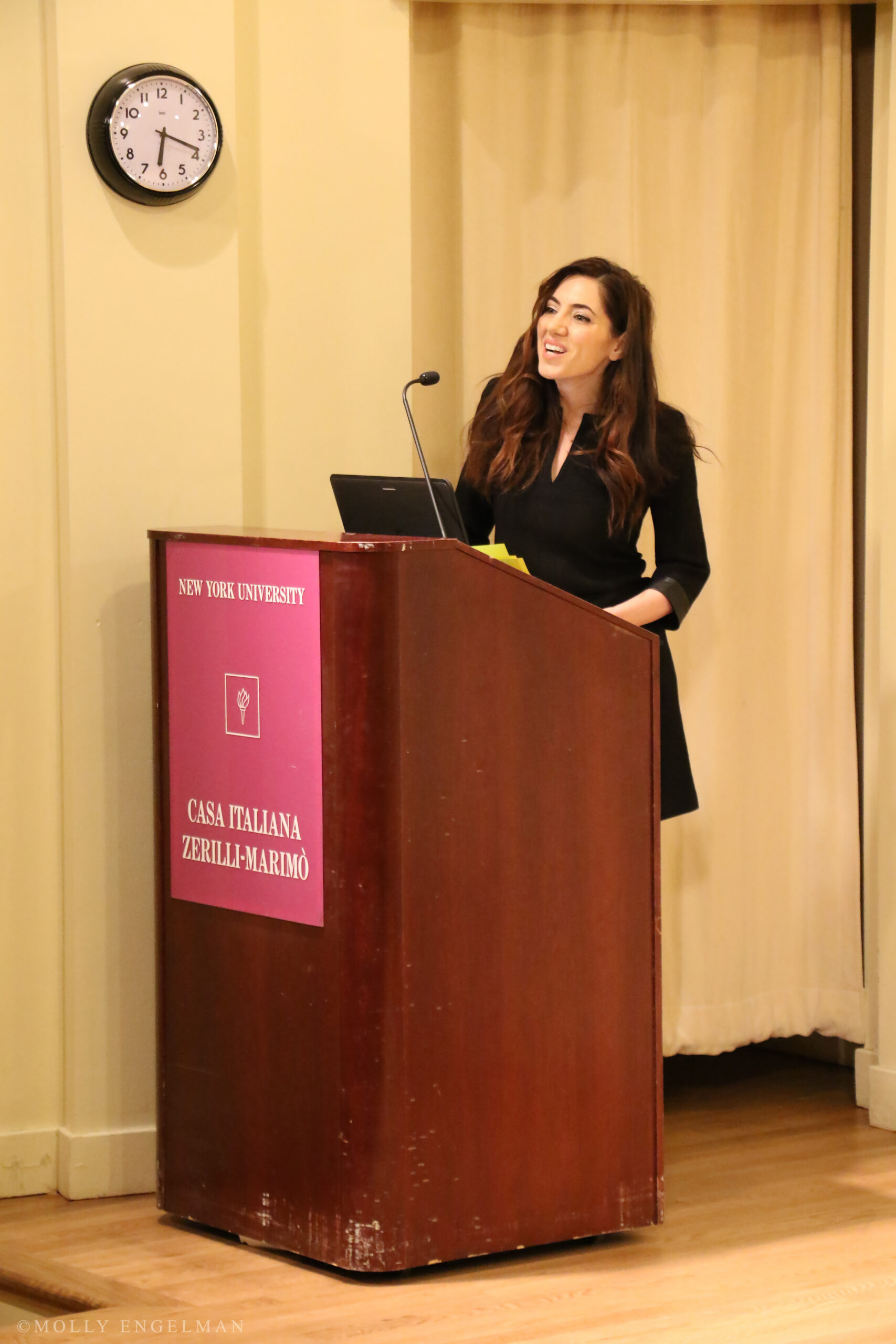 speaker-talking-from-the-triangle-fire-memorial-screening-and-panel-at-casa-italiana