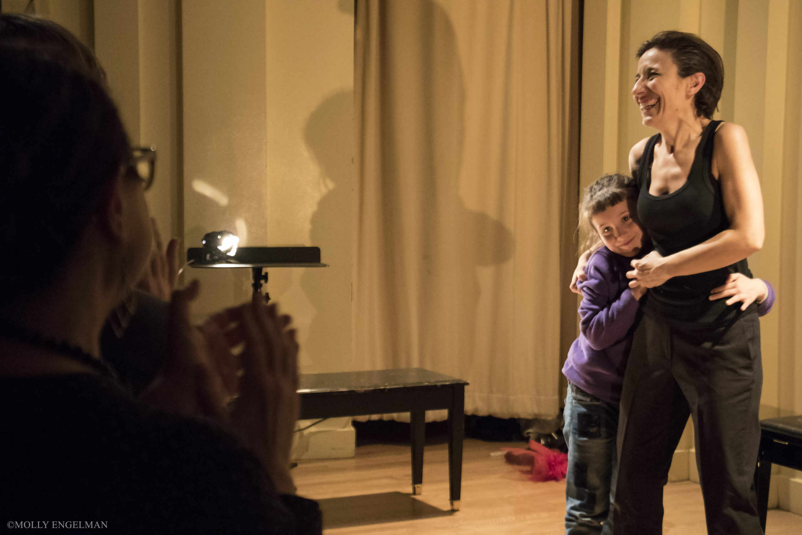 small-girl-hugging-a-lady-smiling-from-in-scena-italian-theater-festival-ny-at-casa-italiana