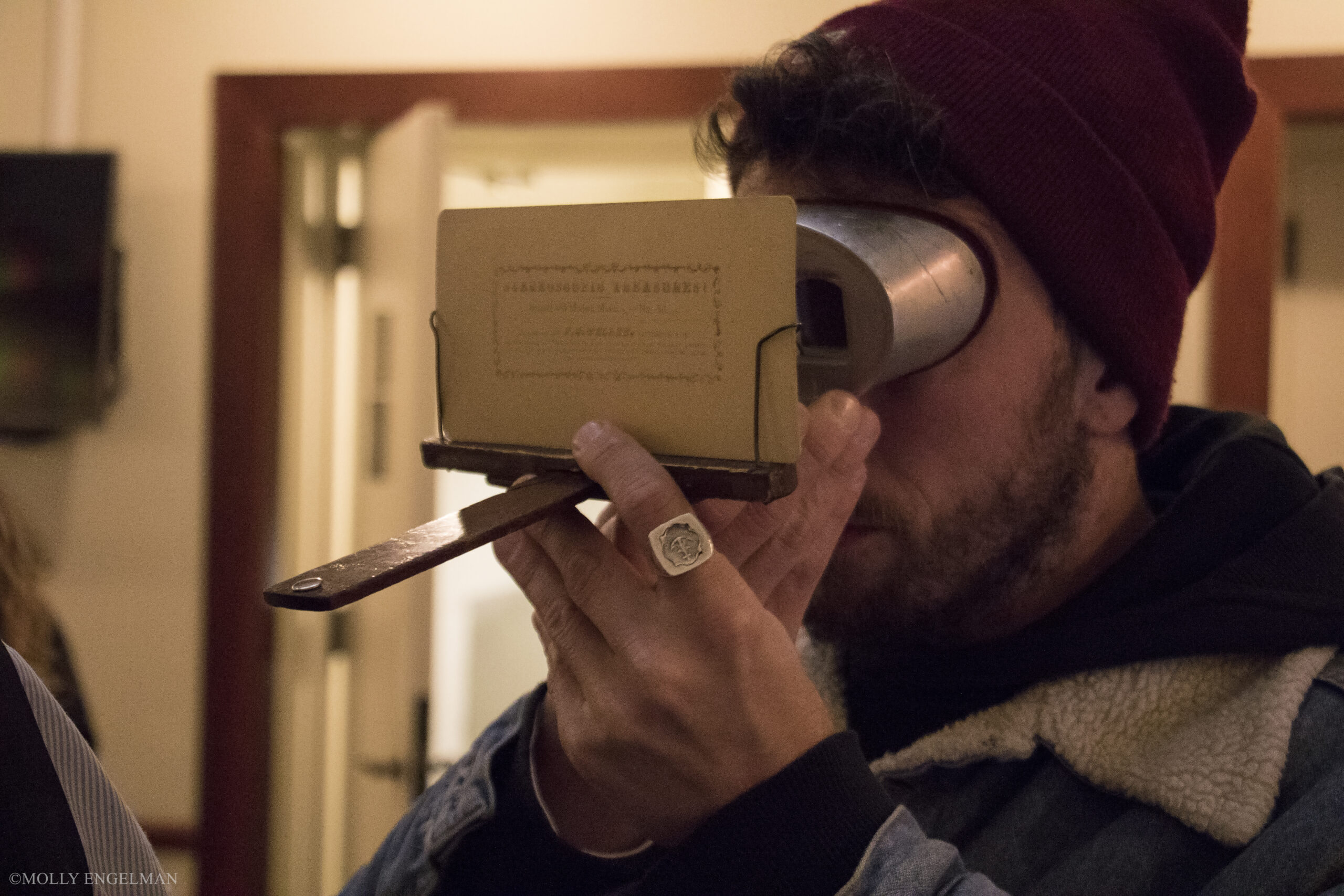 man-using-binoculars-from-in-scena-italian-theater-festival-ny-at-casa-italiana