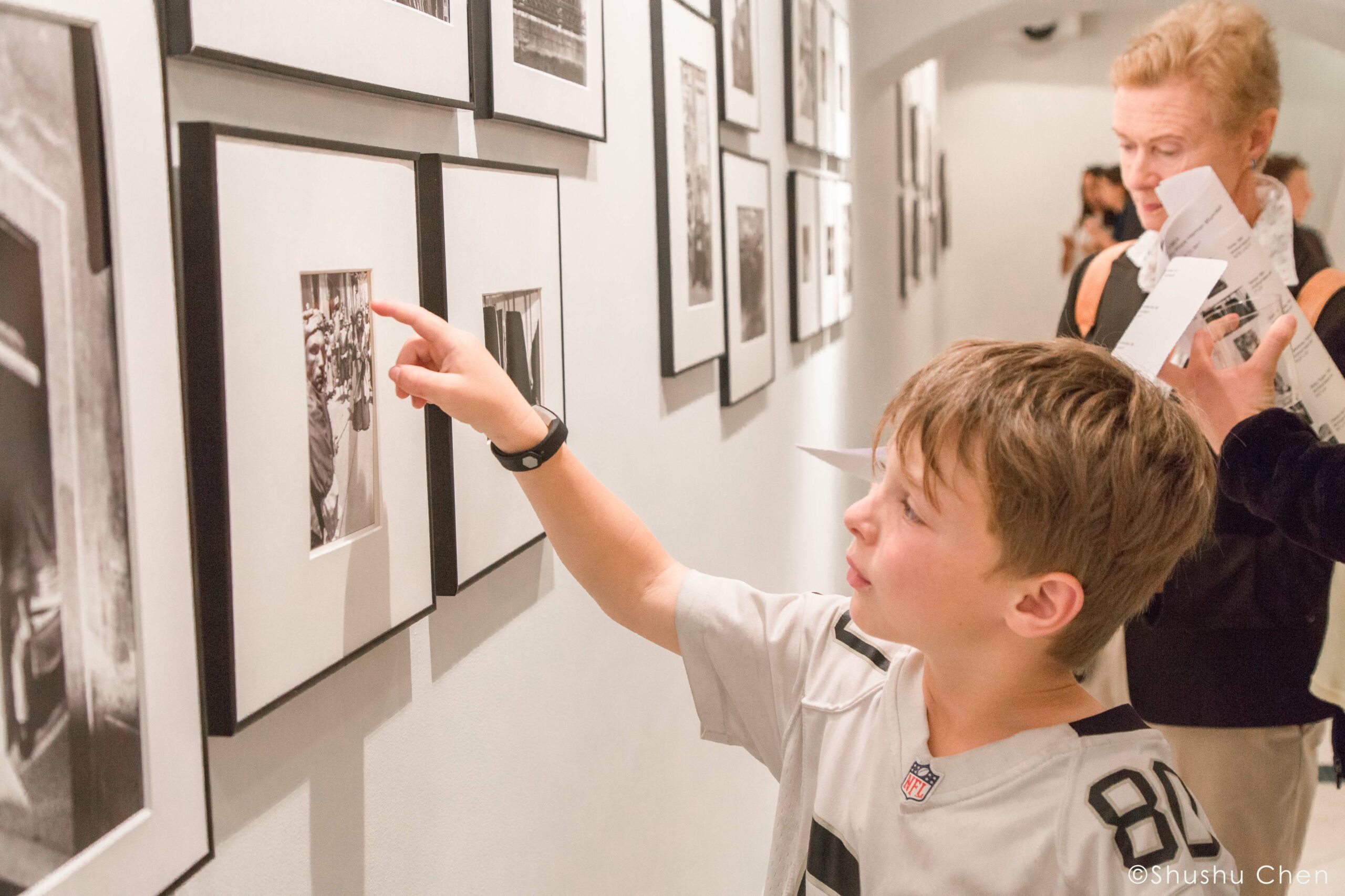 boy-seeing-artwork-from-exhibition-opening-vintage-italy-1964-at-casa-italiana