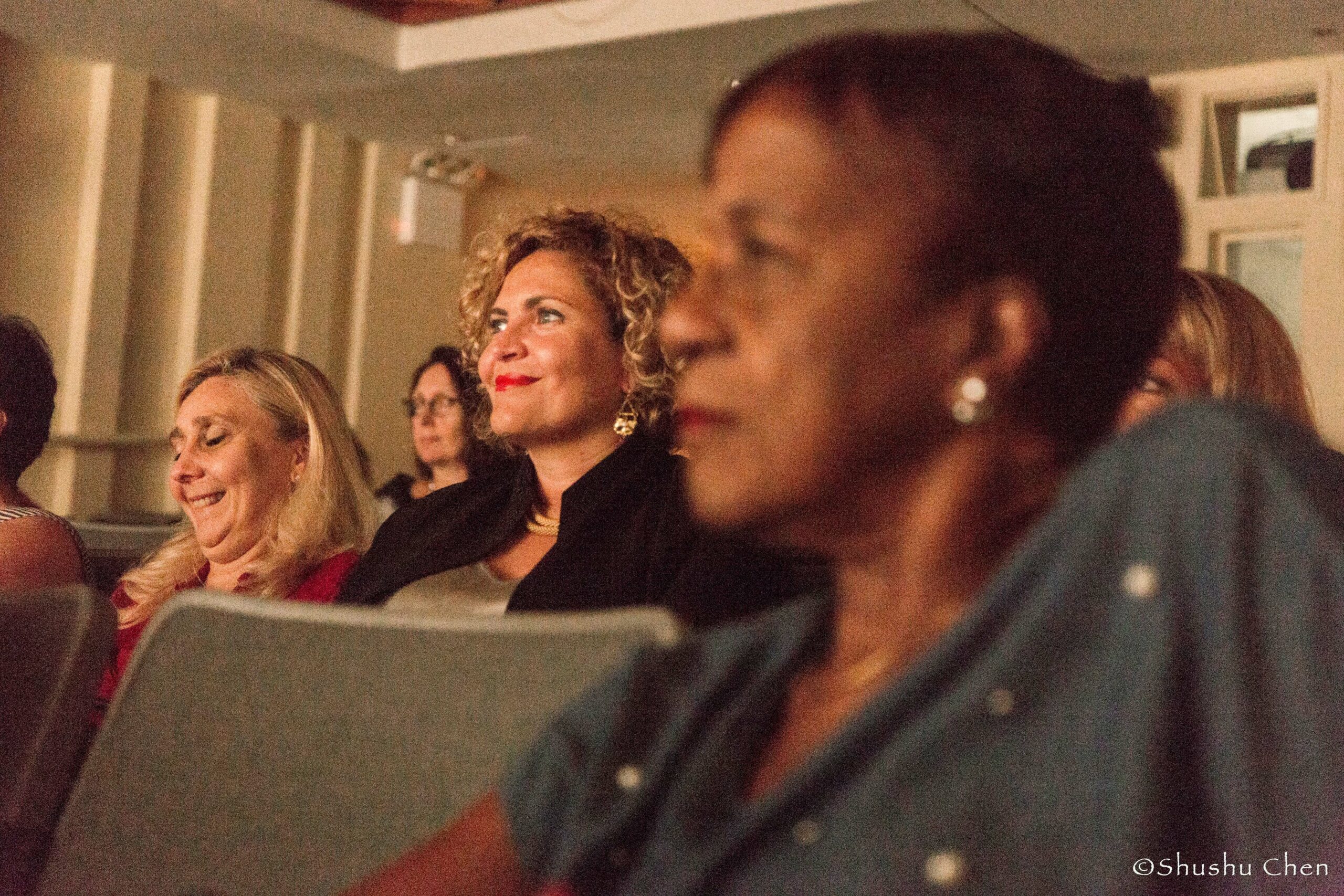 spectators-smiling-from-theatrical-performance-at-casa-italiana