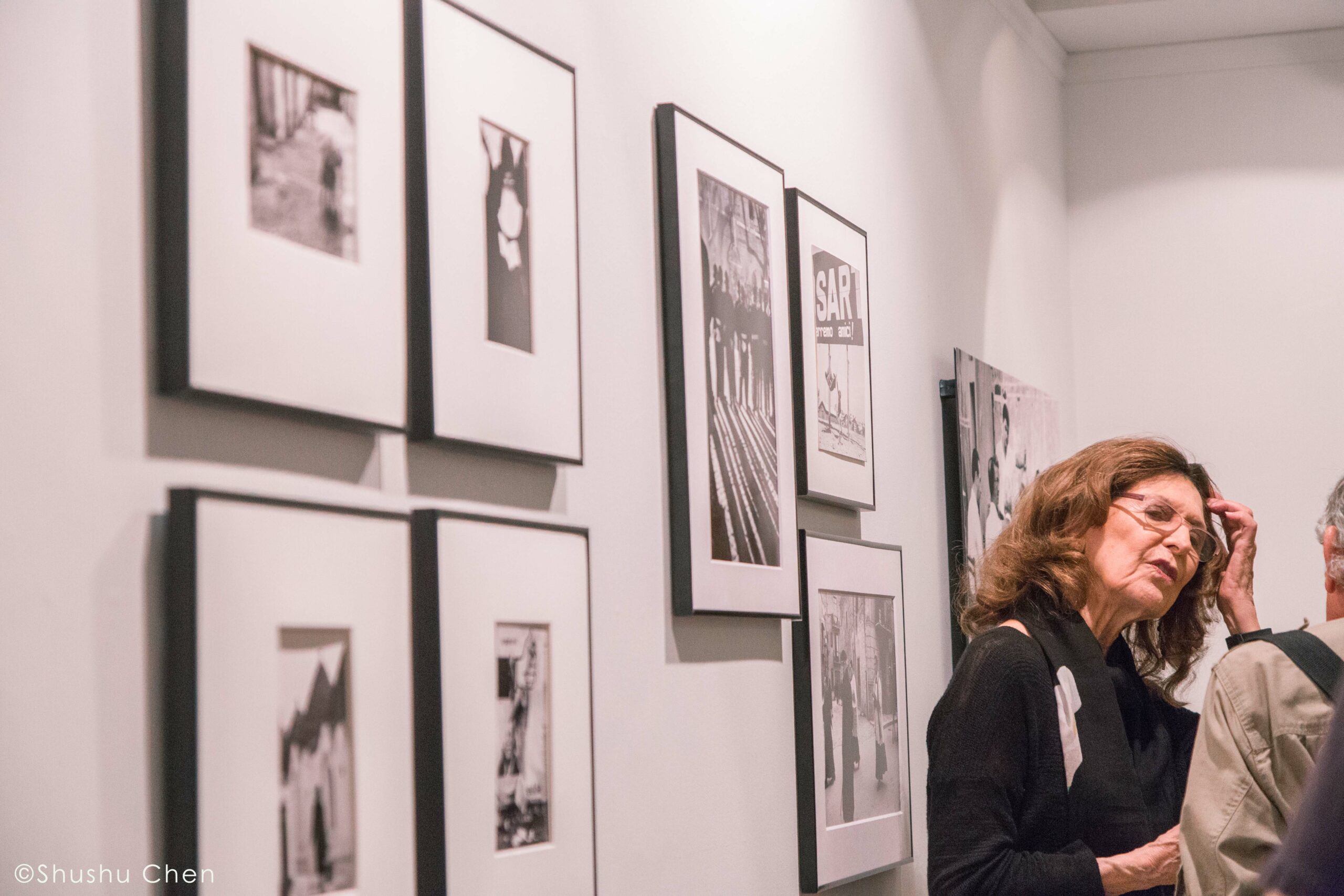woman-and-artworks-on-wall-from-exhibition-opening-vintage-italy-1964-at-casa-italiana