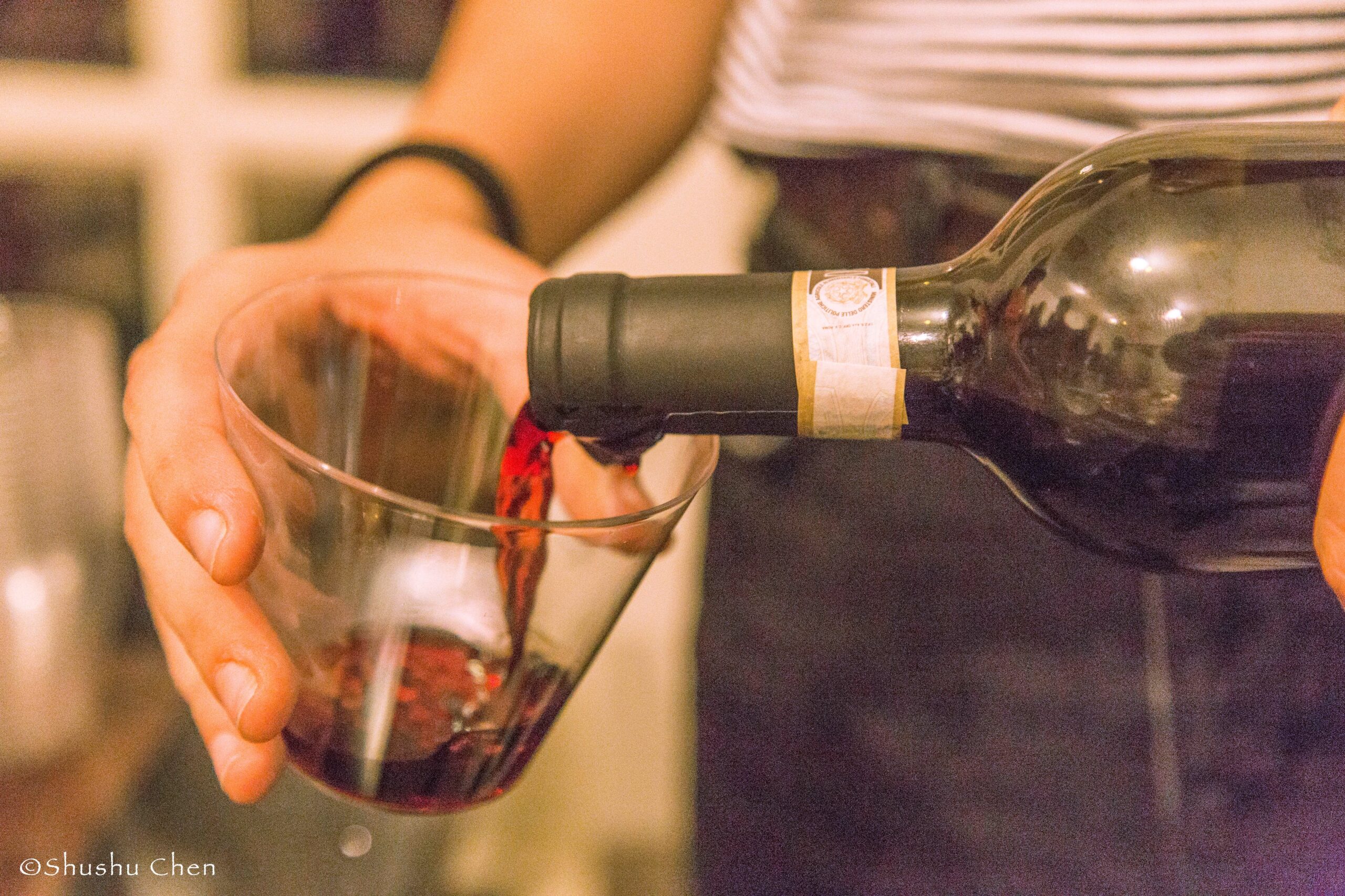 wine-being-poured-in-glass-from-theatrical-performance-at-casa-italiana