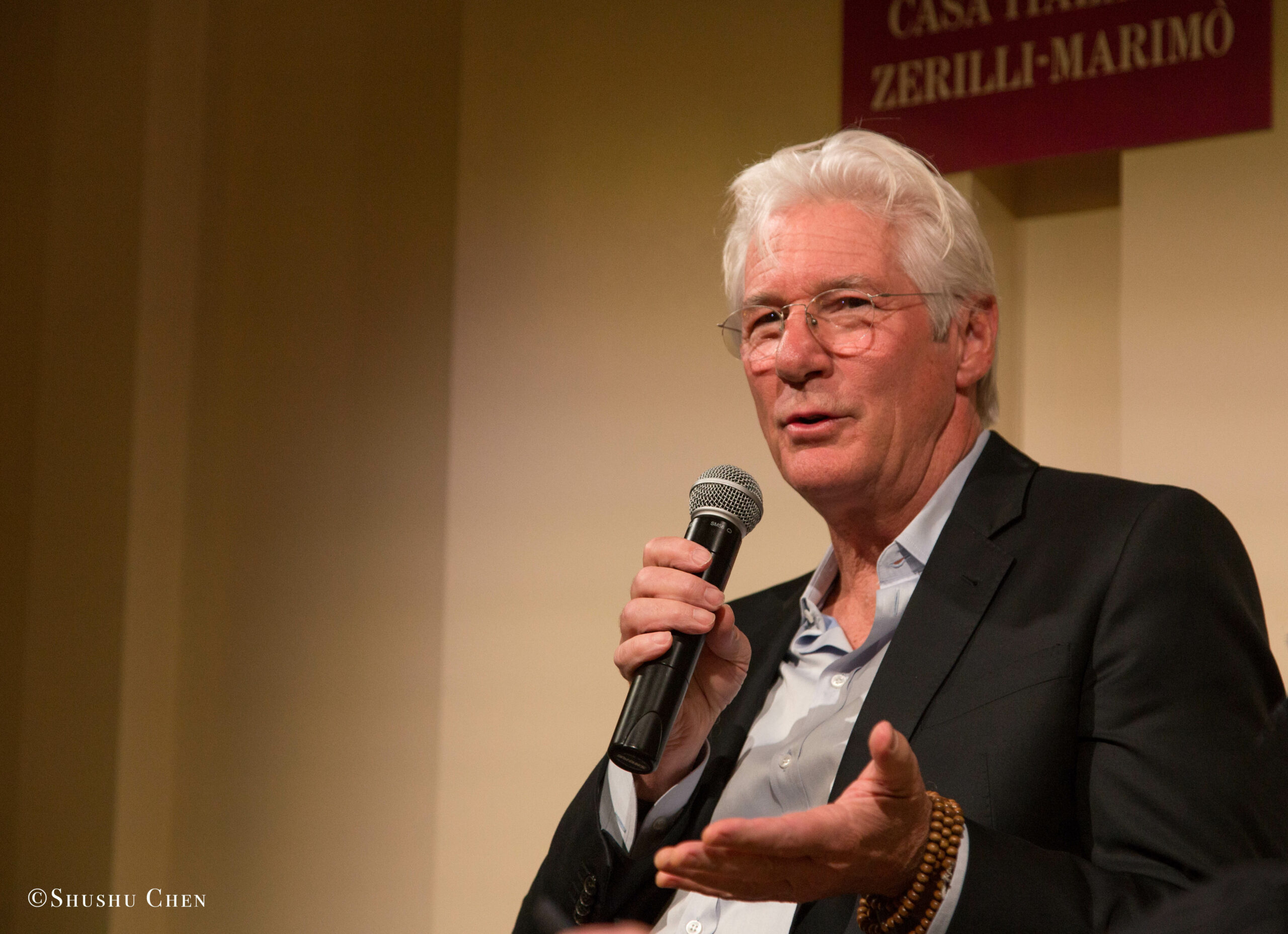 speaker-talking-from-presentation-richard-gere-reads-italo-calvino-at-casa-italiana