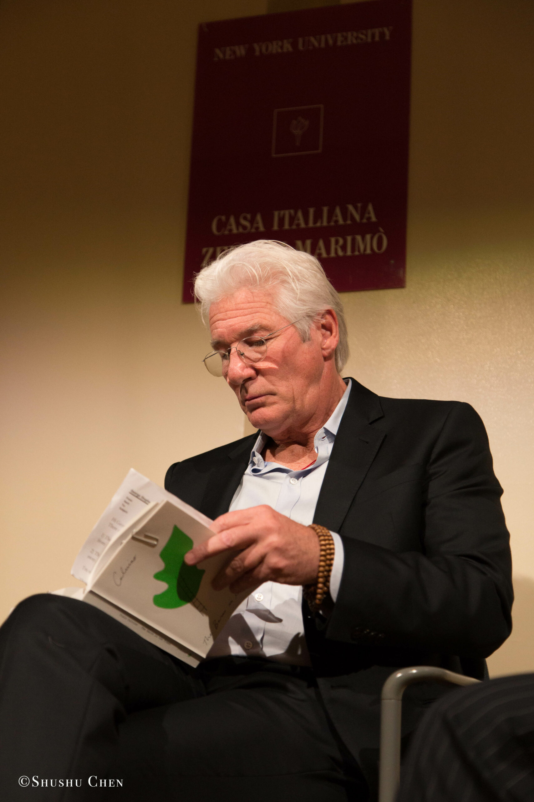 speaker-reading-book-from-presentation-richard-gere-reads-italo-calvino-at-casa-italiana
