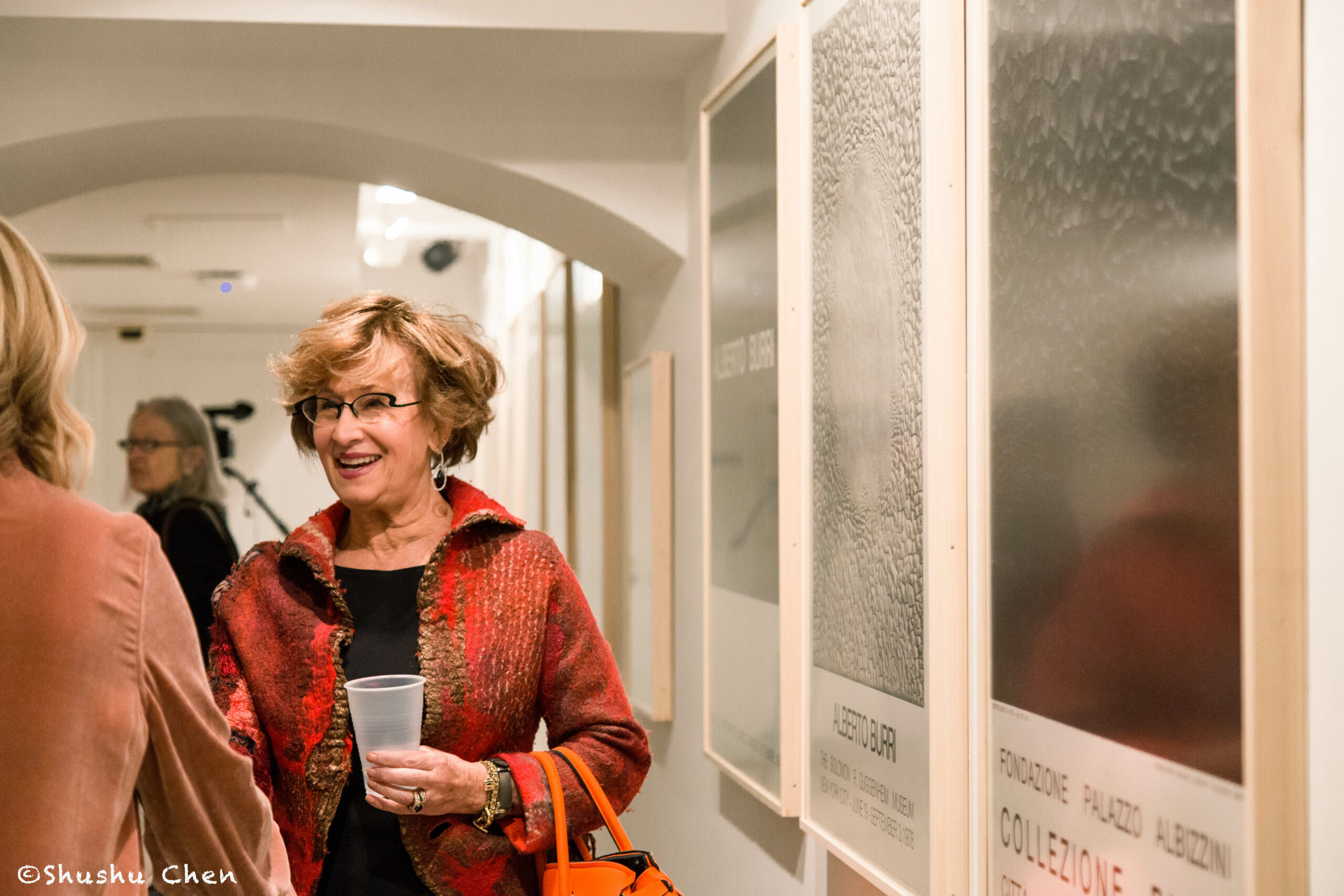woman-smiling-from-exhibition-opening-burri-posters-at-casa-italiana