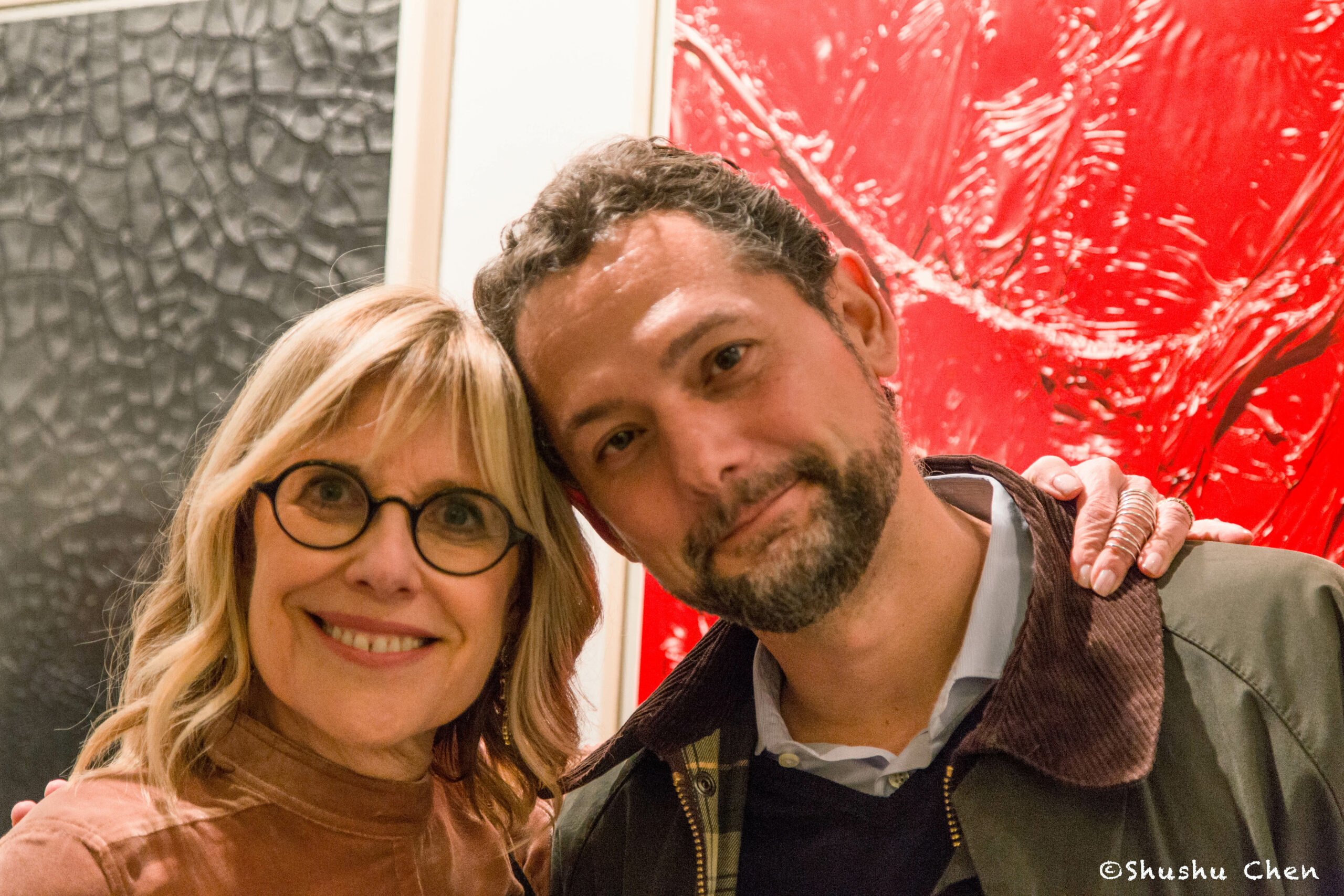 man-and-woman-smiling-from-exhibition-opening-burri-posters-at-casa-italiana