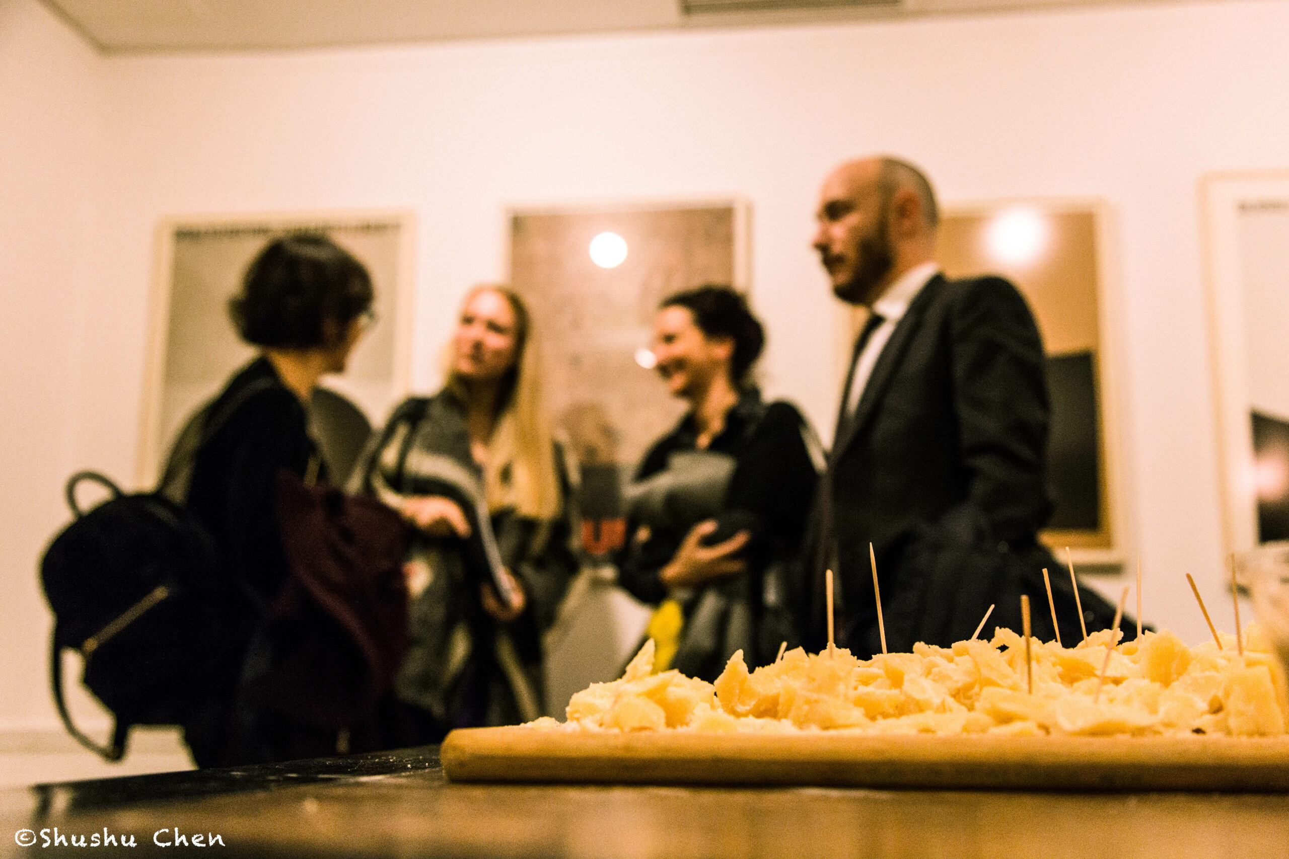 cheese-and-guests-interacting-from-exhibition-opening-burri-posters-at-casa-italiana