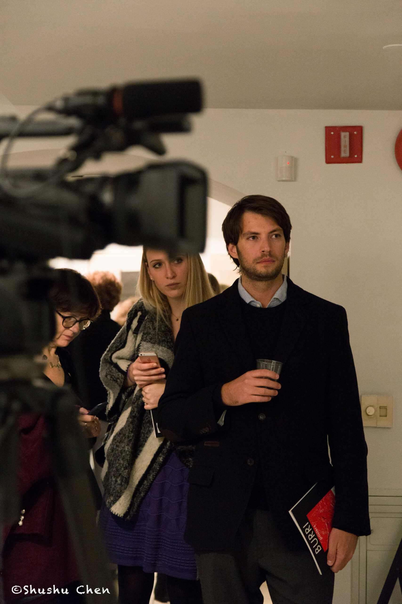 people-and-camera-from-exhibition-opening-burri-posters-at-casa-italiana
