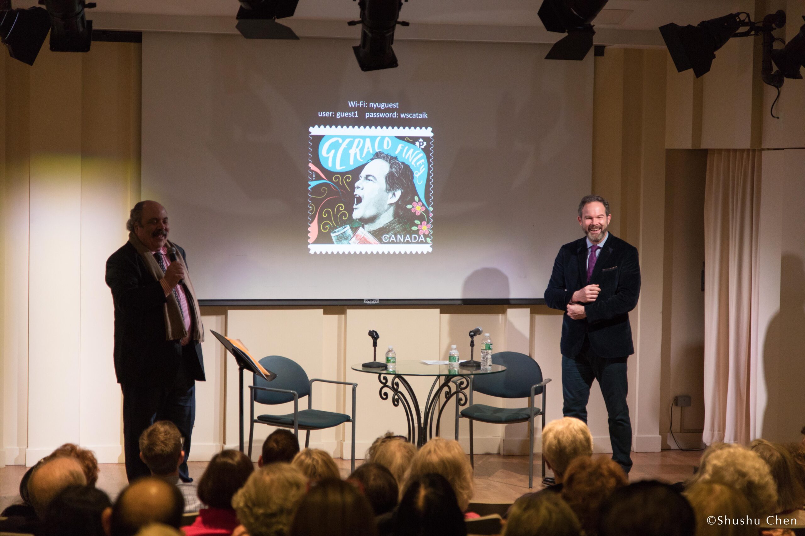 speakers-smiling-and-image-being-displayed-on-projector-screen-from-adventures-in-italian-opera-gerald-finley-at-casa-italiana