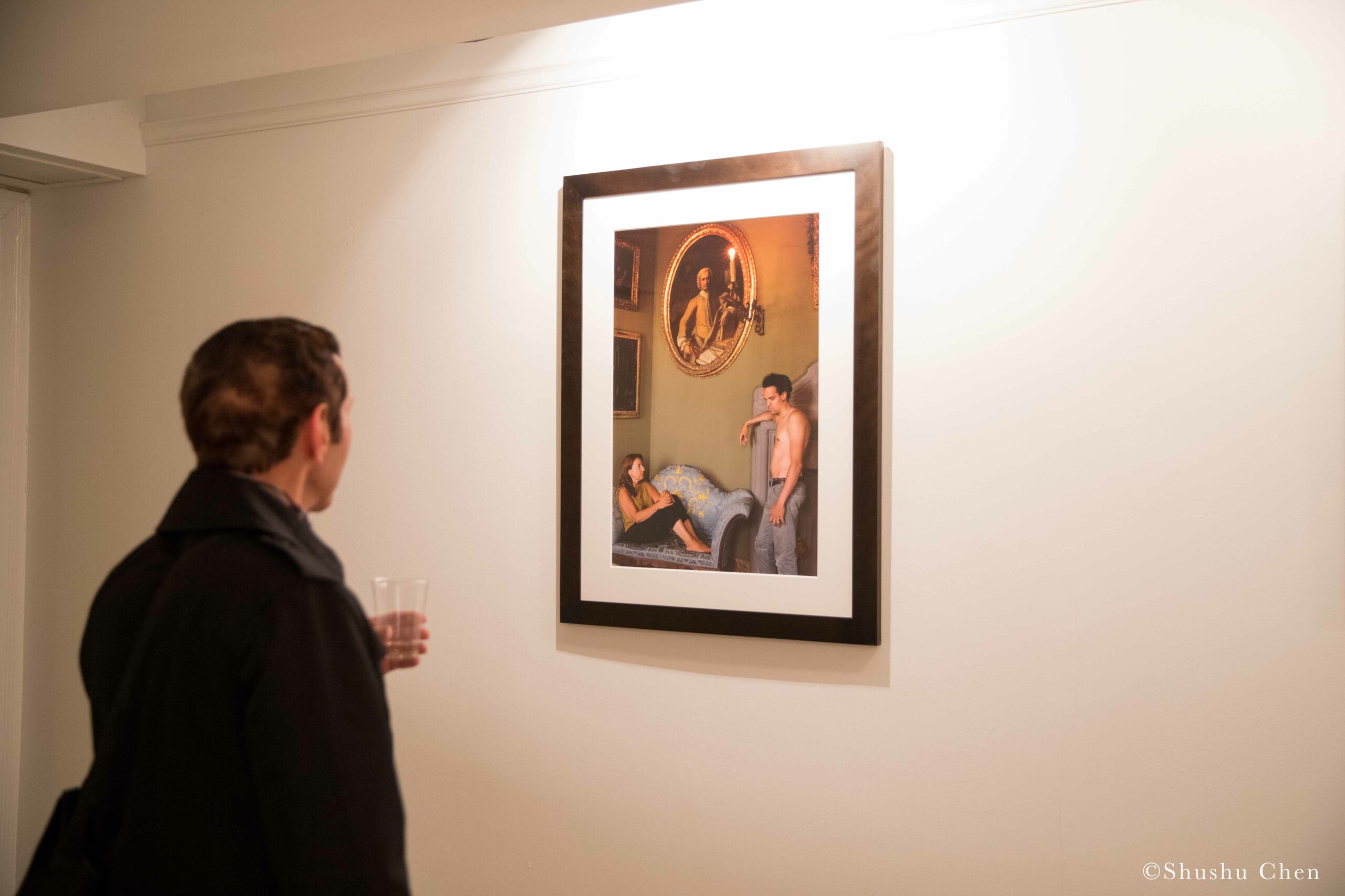 man-seeing-artwork-on-wall-from-exhibition-opening-resignifications-revisited-at-casa-italiana
