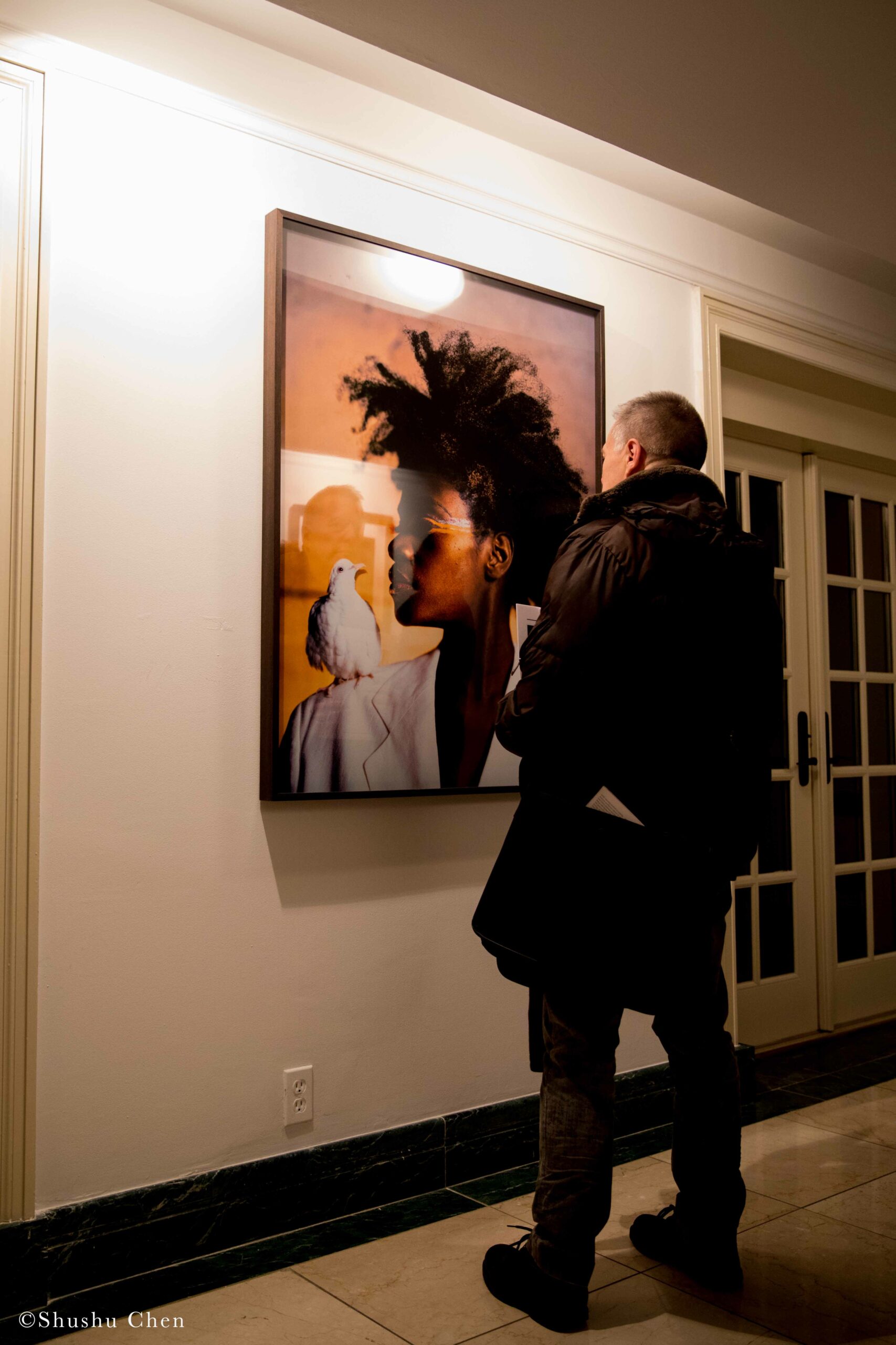 man-seeing-artwork-on-wall-from-exhibition-opening-resignifications-revisited-at-casa-italiana