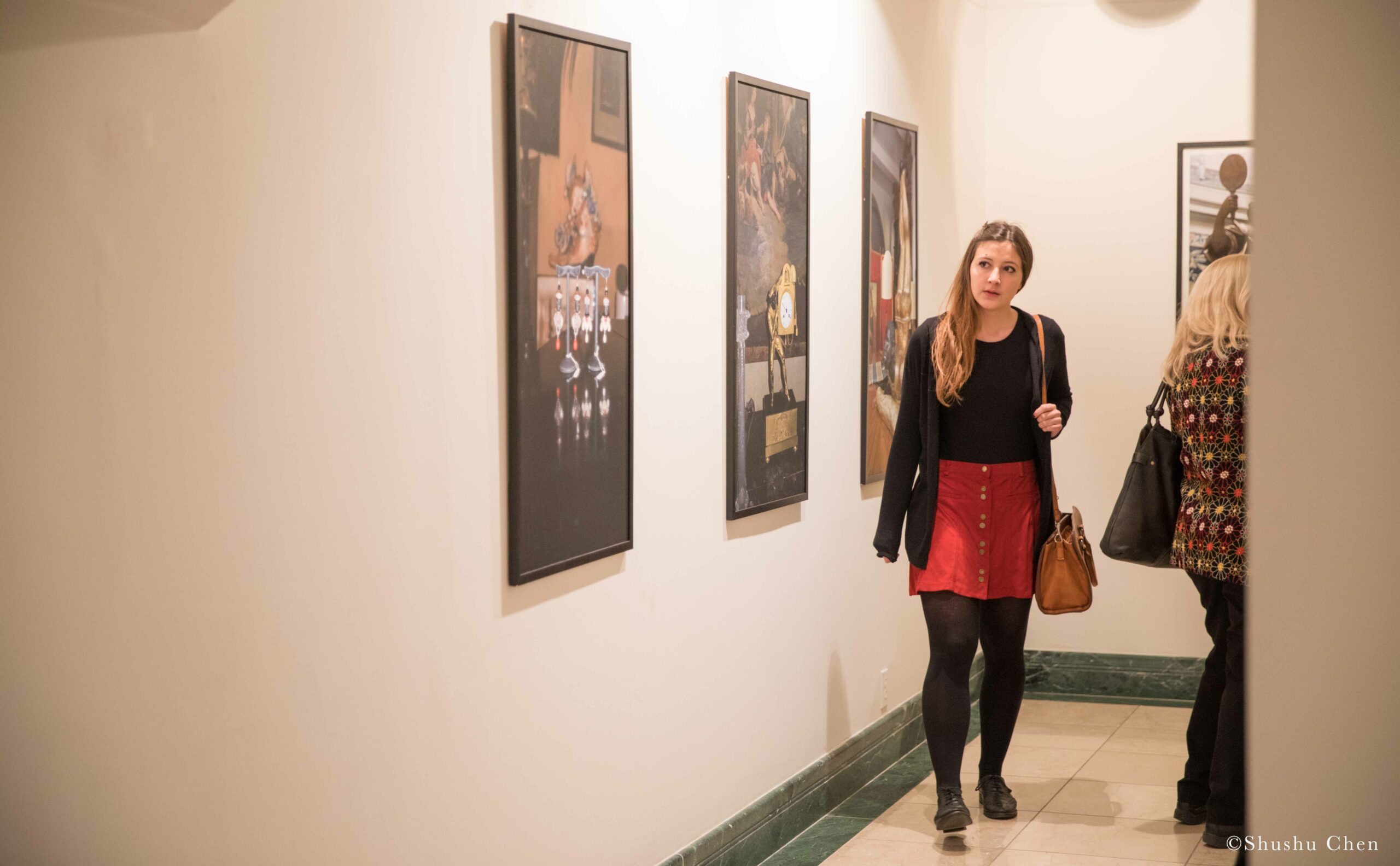 girl-seeing-artwork-on-wall-from-exhibition-opening-resignifications-revisited-at-casa-italiana