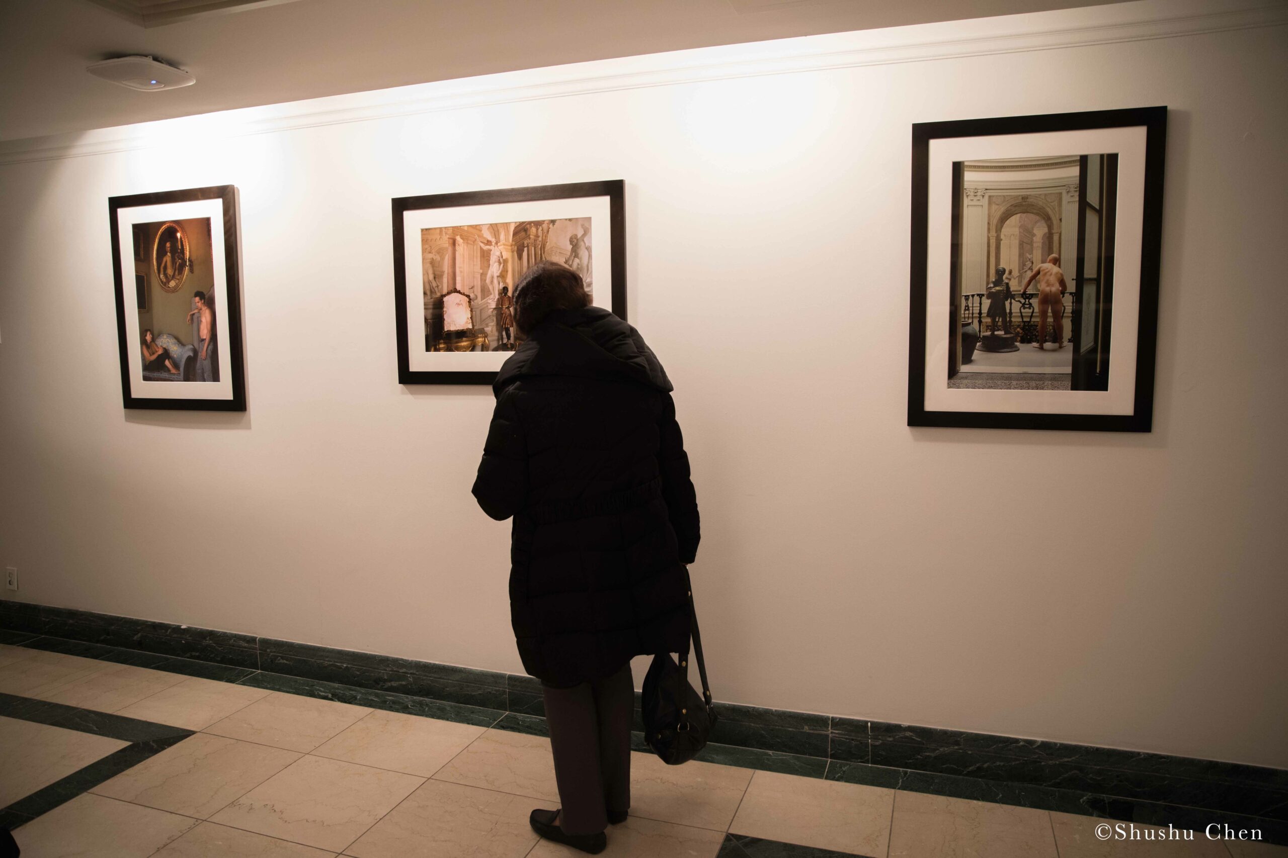 woman-seeing-artwork-on-wall-from-exhibition-opening-resignifications-revisited-at-casa-italiana