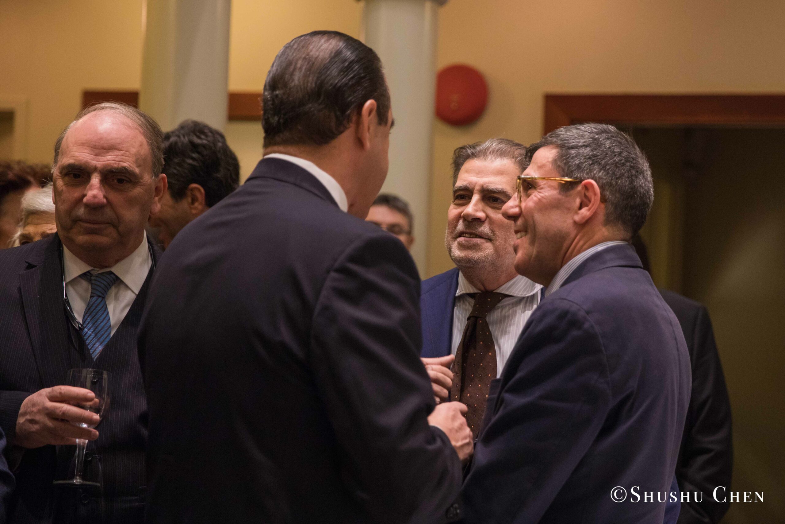 four-businessmen-in-suits-engaging-in-a-conversation-from-Italian-table-talks-at-casa-italiana