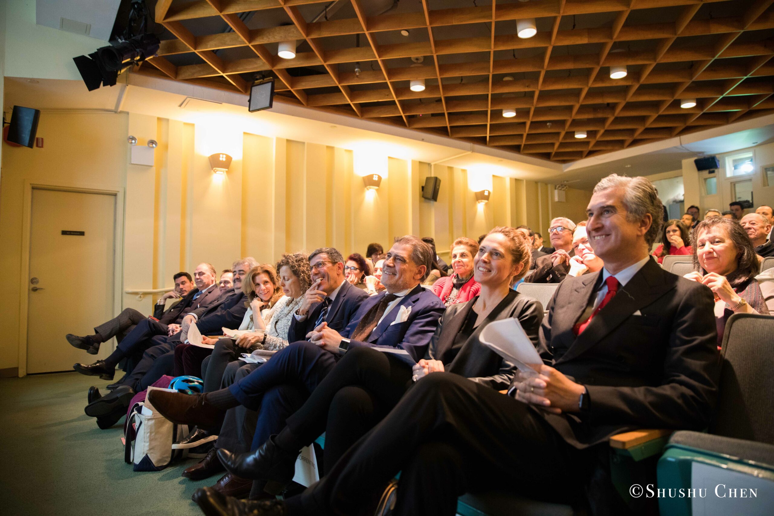 a-diverse-audience-seated-in-a-lecture-hall-attentively-watching-a-presentation-from-Italian-table-talks-at-casa-italiana