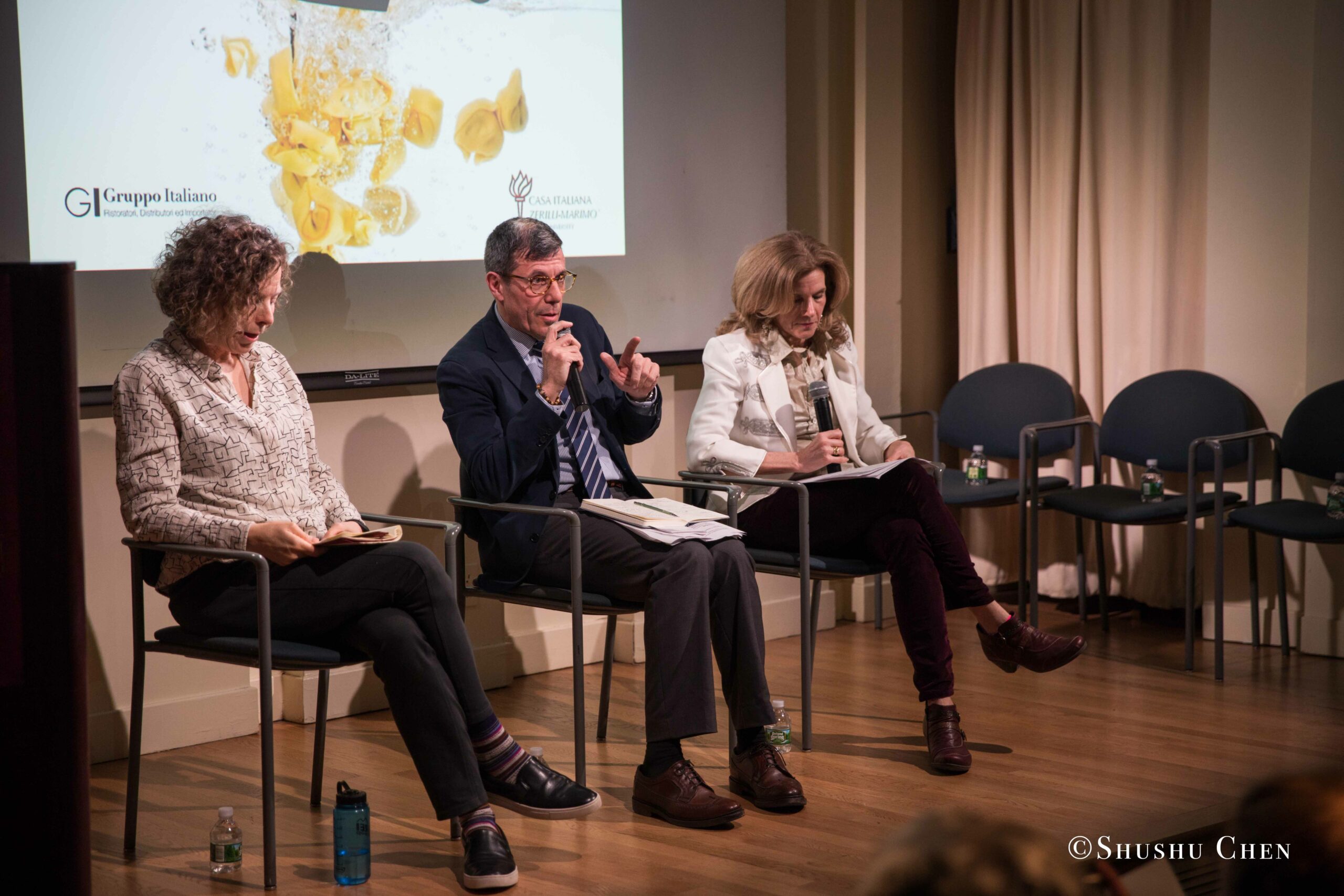 three-people-sit-on-stage-at-a-panel-discussion-from-Italian-table-talks-at-casa-italiana