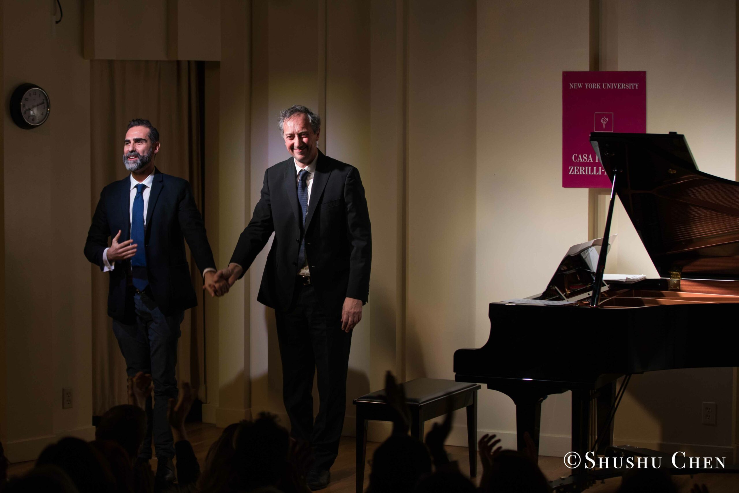 speaker-and-artist-holding-hands-from-concert-an-evening-with-piano-music-of-roberto-scarcella-perino-at-casa-italiana