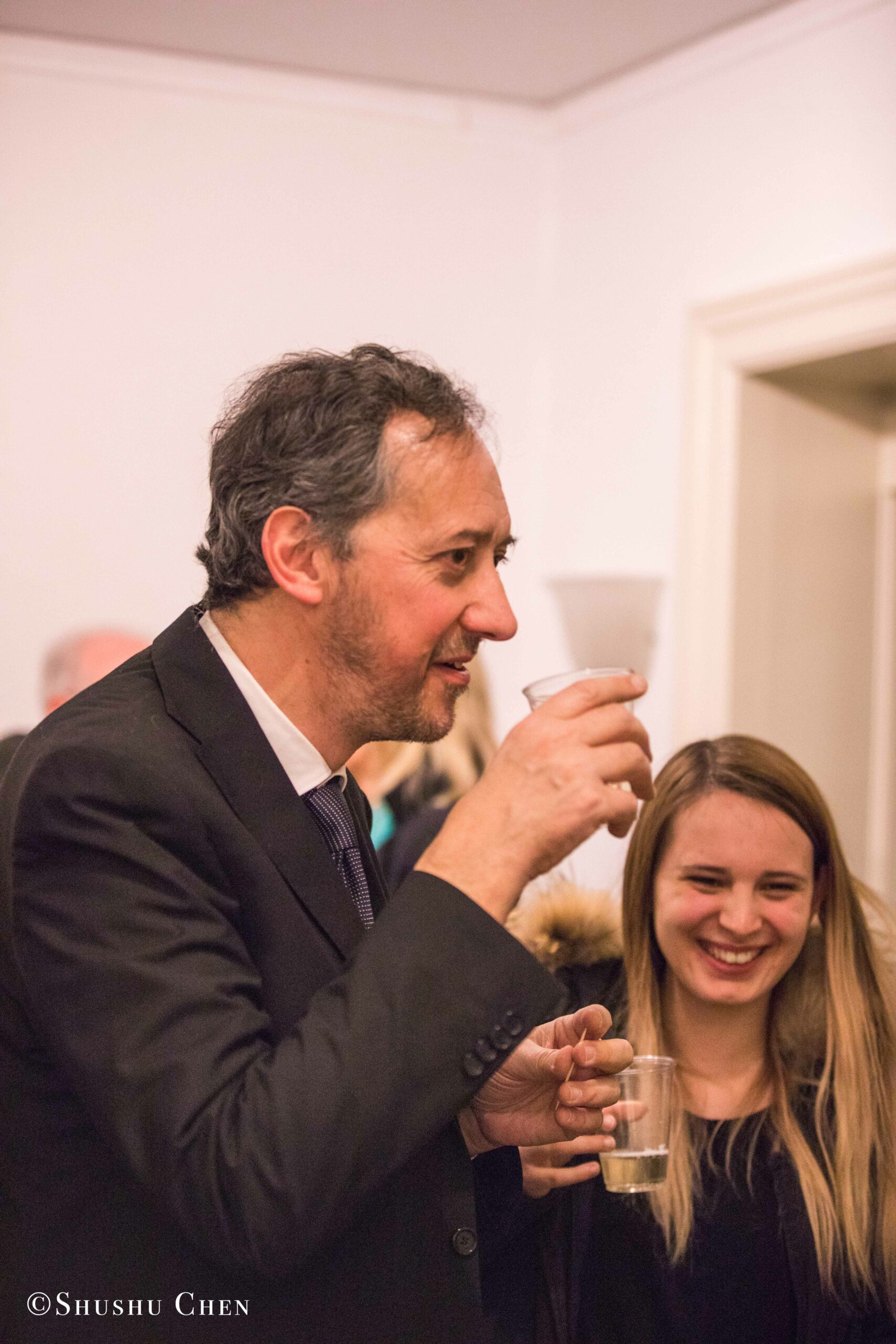 man-drinking-wine-and-woman-smiling-from-concert-an-evening-with-piano-music-of-roberto-scarcella-perino-at-casa-italiana